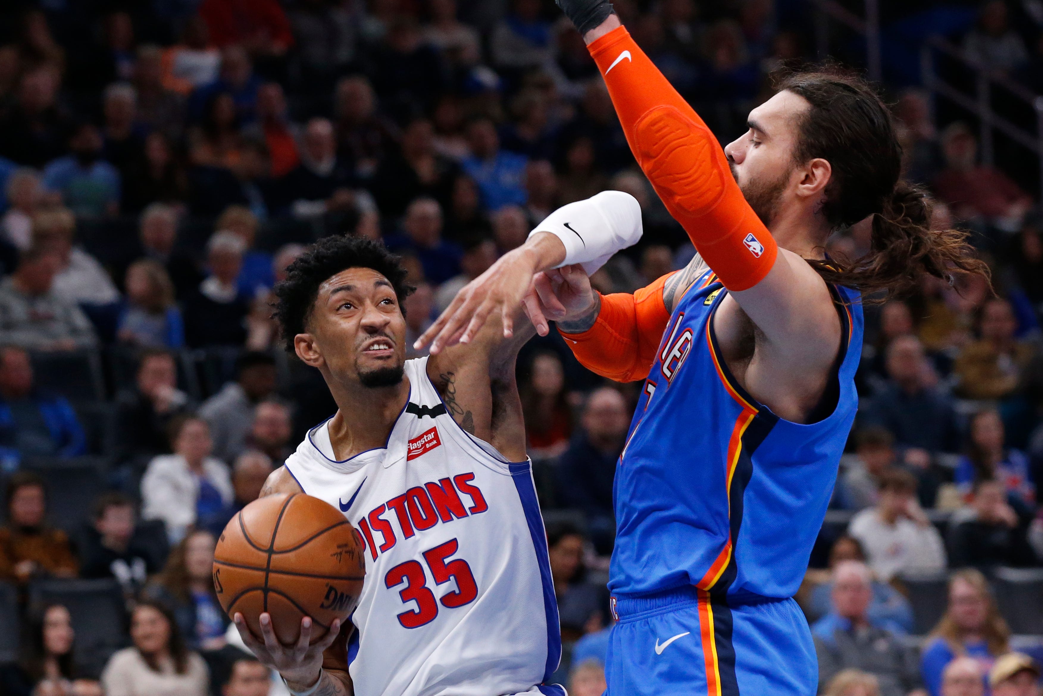 Detroit Pistons forward Christian Wood (35) drives to the basket in front of Oklahoma City Thunder center Steven Adams during the first half.