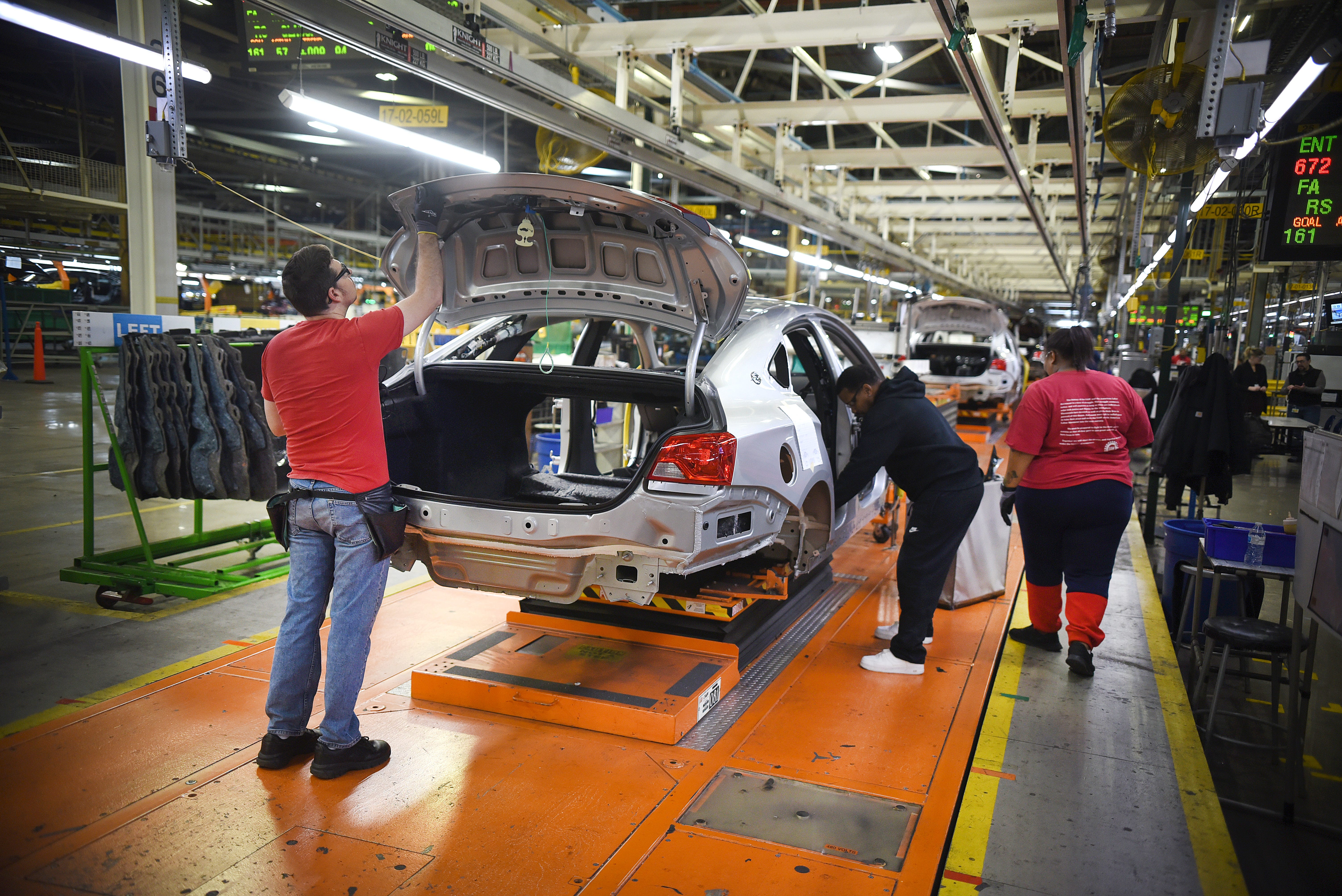 Assembly line workers at the General Motors Detroit-Hamtramck plant work on Chevrolet final Impalas built at the facility.