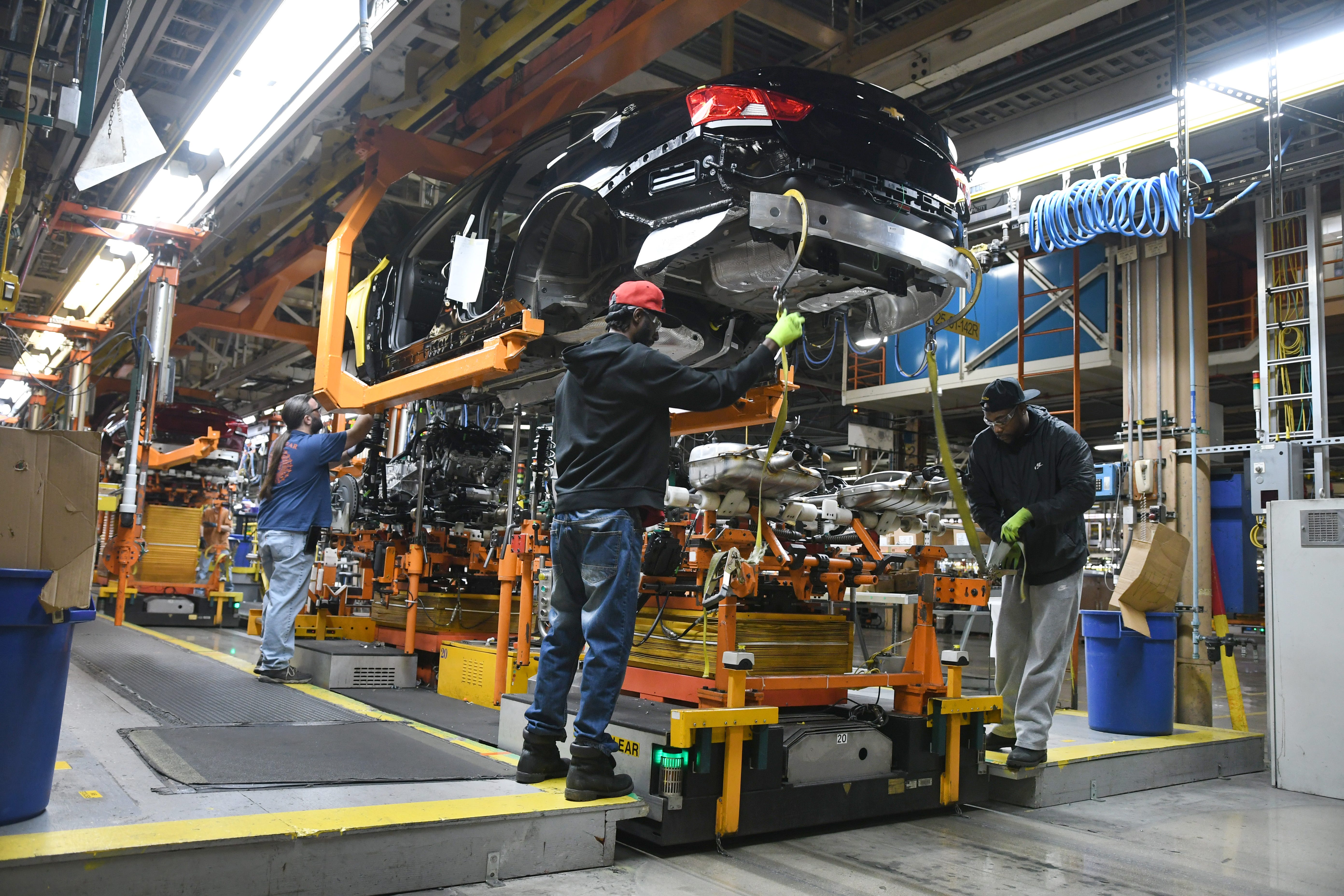 Assembly line workers at the General Motors Detroit-Hamtramck plant continue working on the Chevrolet Impala as the plant will be converting from internal-combustion production to EV.