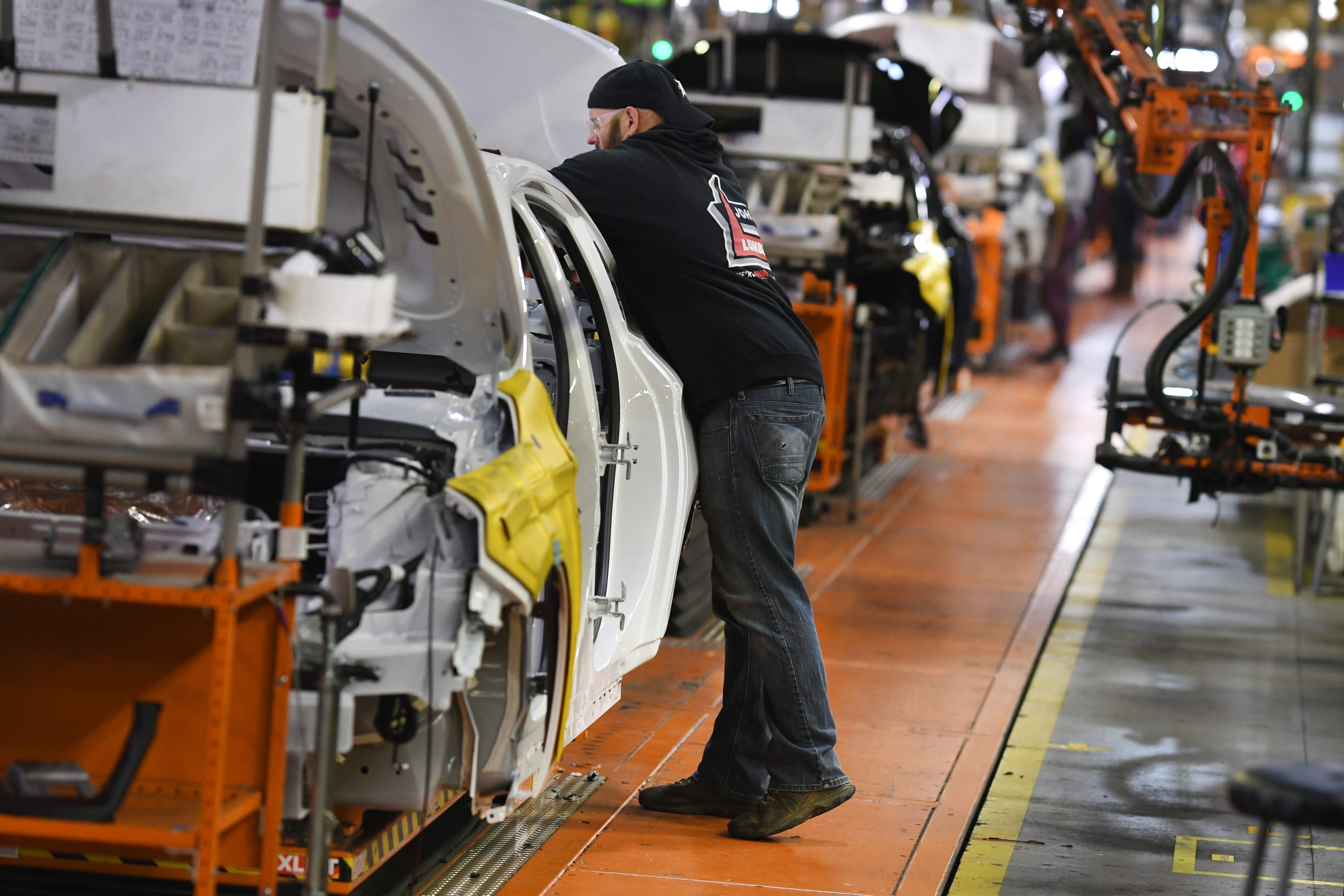 Assembly line workers at the General Motors Detroit-Hamtramck plant finish the last Chevrolet Impalas built at the plant. It will be the first fully electric plant for GM.