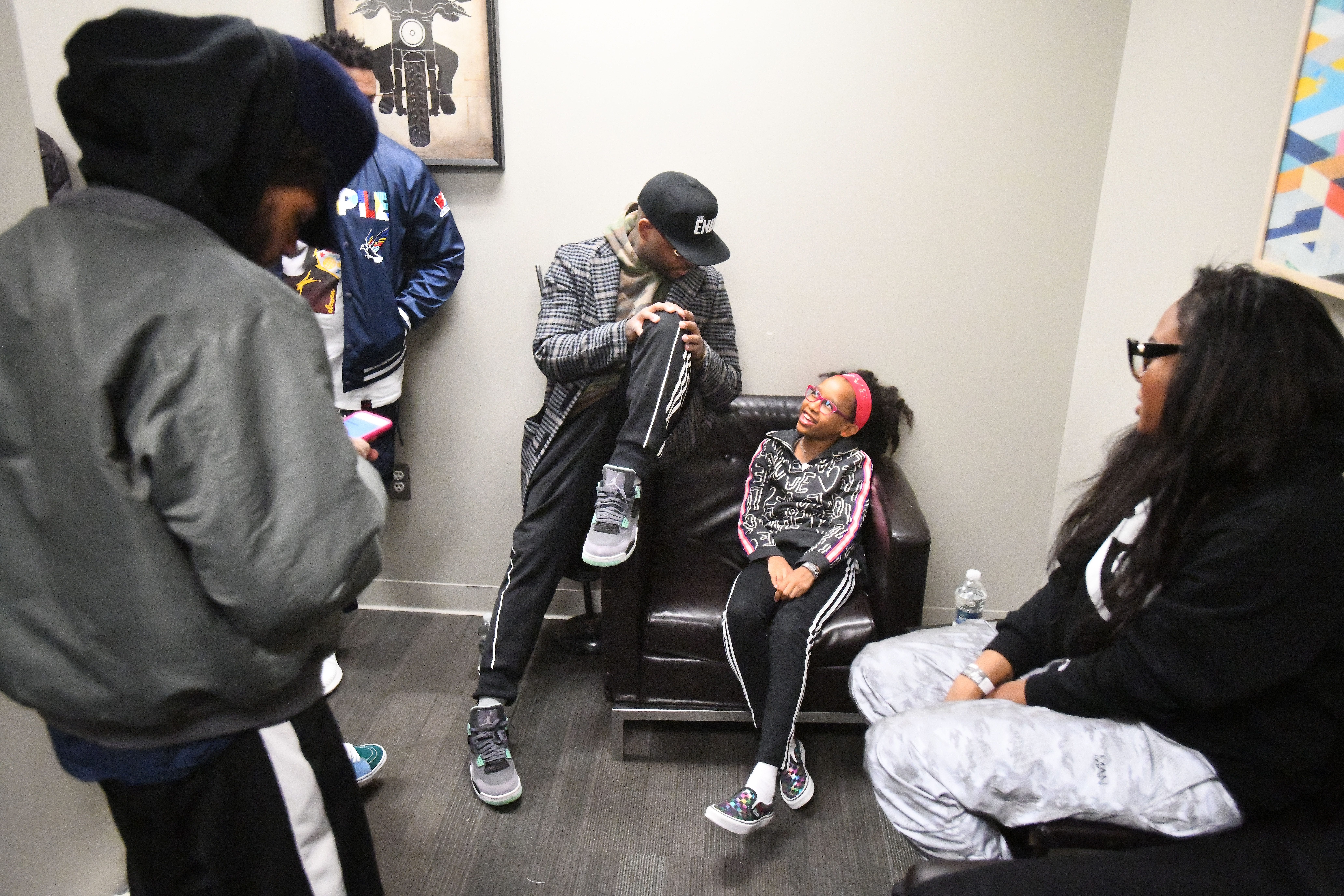 Rapper and songwriter Royce da 5'9", Ryan Montgomery,  jokes around with his daughter Lyric Montgomery, 11 in a backstage dressing room with his wife Artegia Montgomery and friends and family before his set.