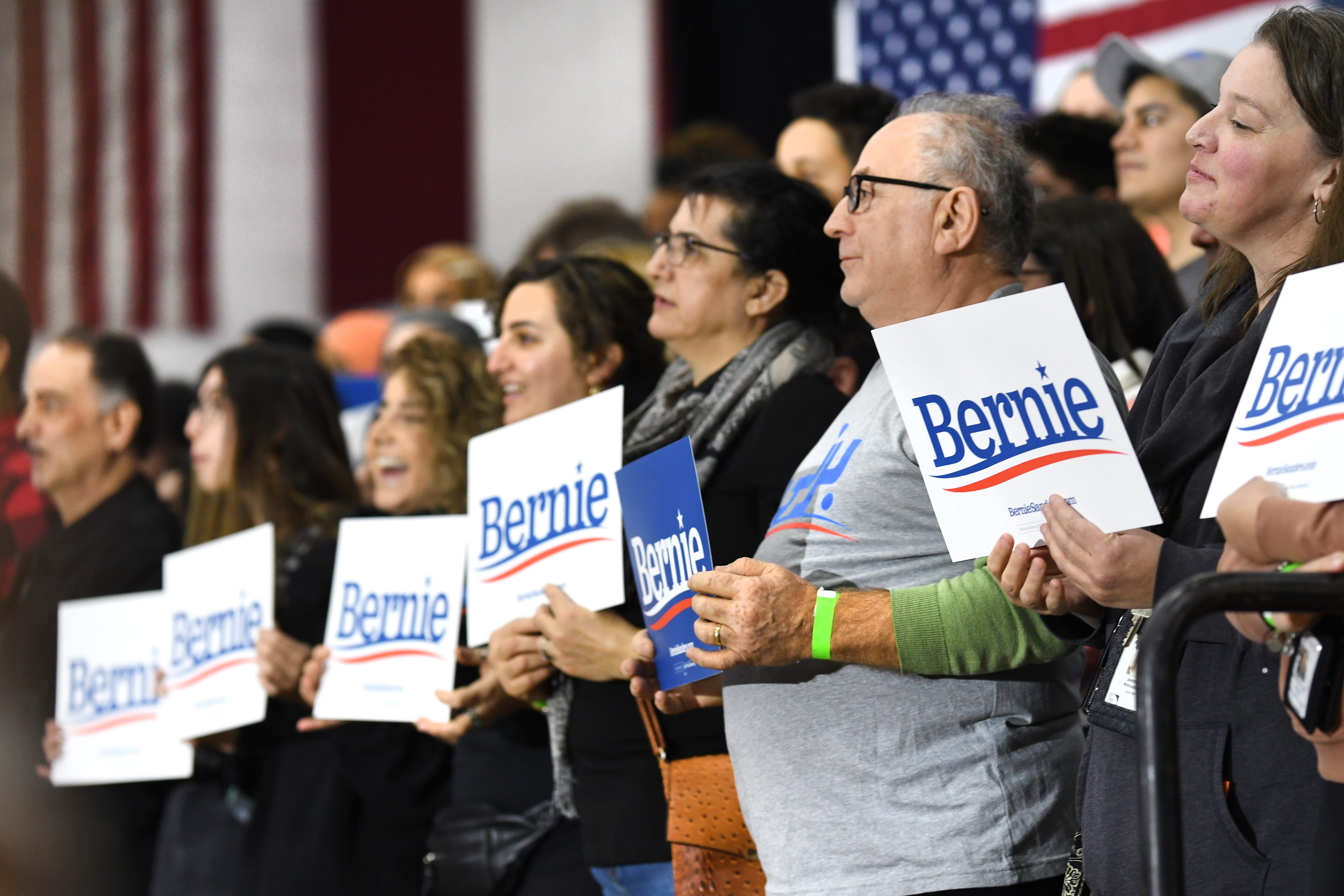 Supporters of Bernie Sanders hold signs at Salina Intermediate School in Dearborn.