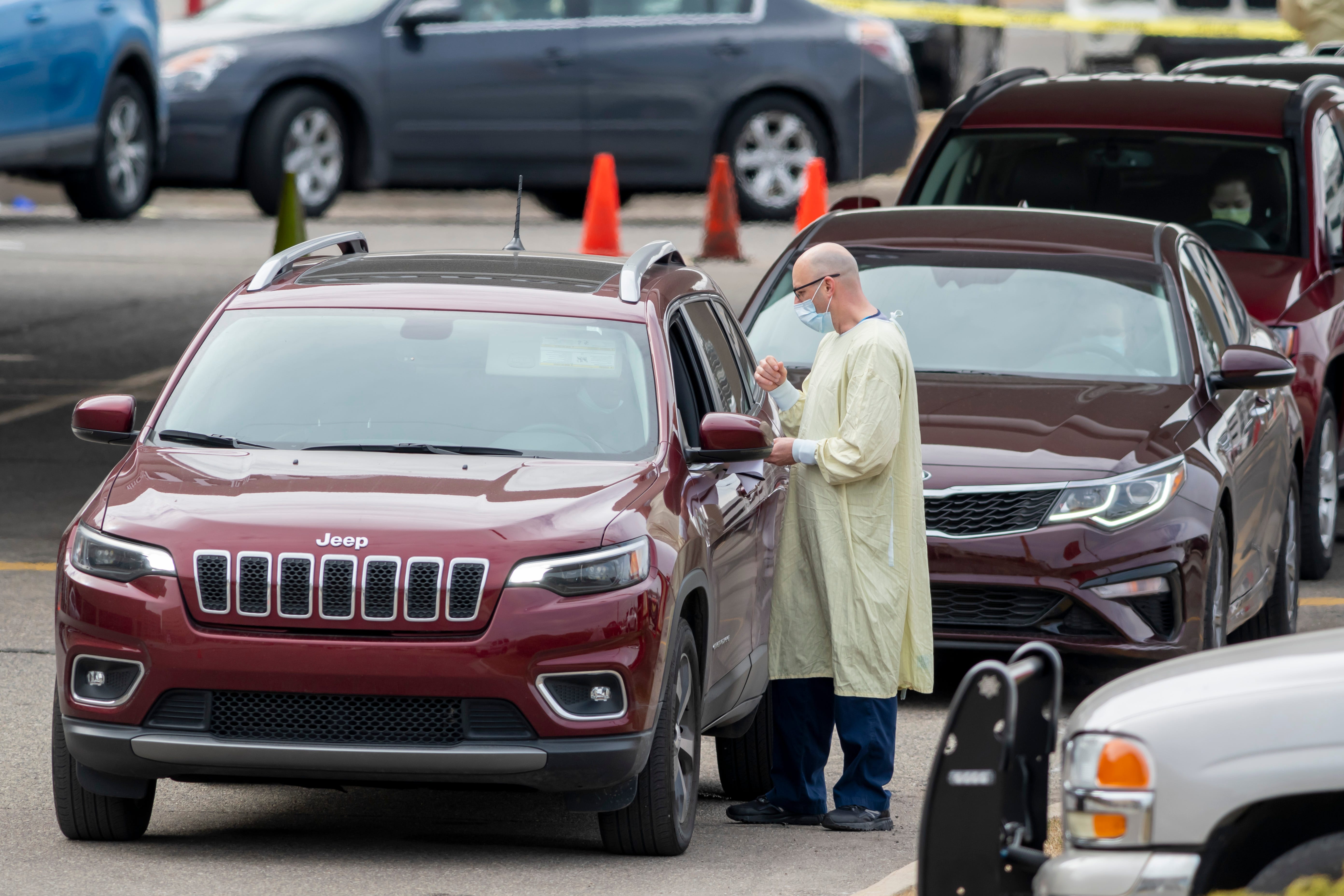 Patients are seen by medical staff during a drive-up screening process at Beaumont hospital in Royal Oak, March 16, 2020. Members of the public concerned that they may be infected with the coronavirus were able to get screening done from their vehicles.