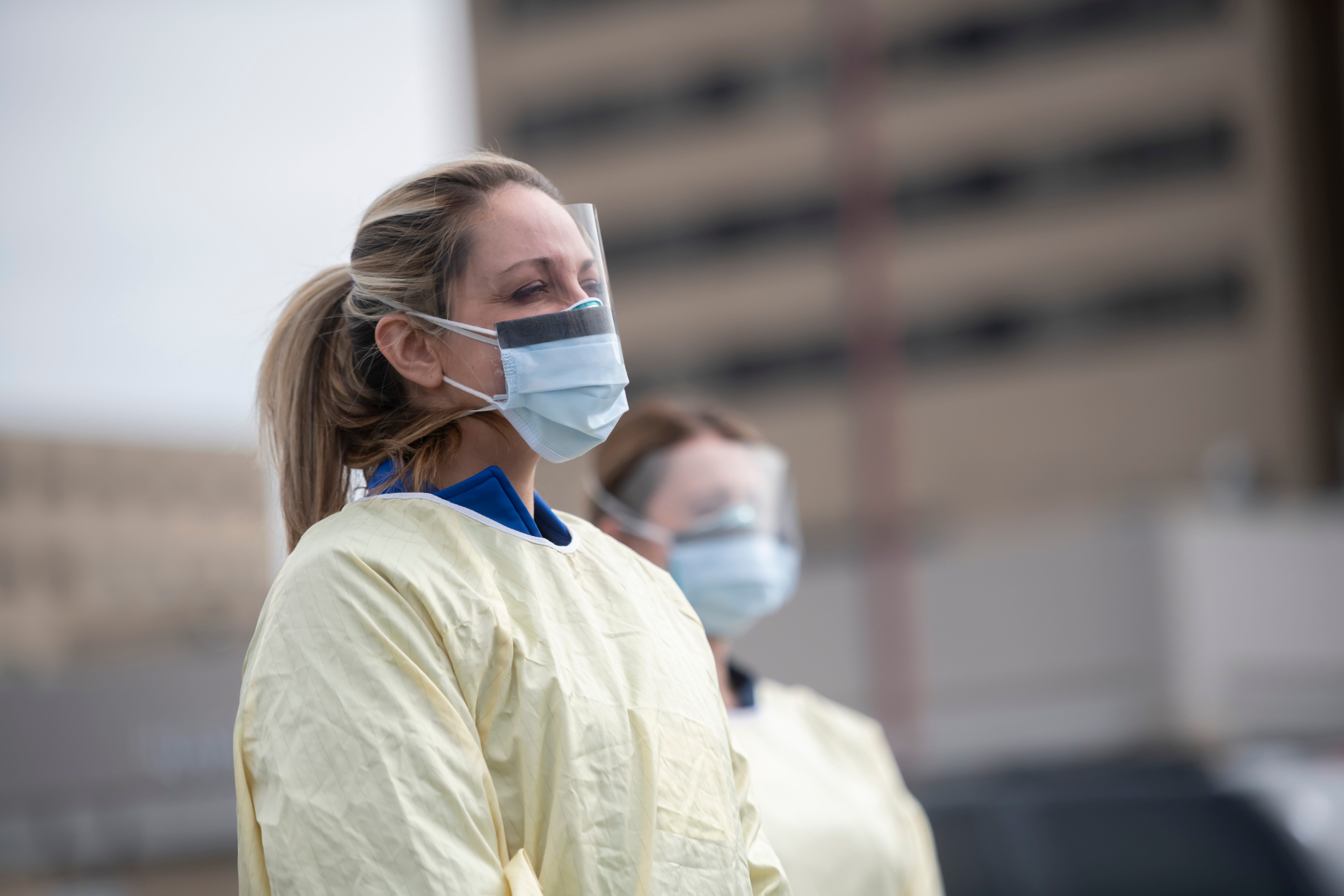 Physician assistant Jessica Hamilton, left, and, registered nurse Amena Beslic, director of the emergency center, stand in front of Beaumont hospital in Royal Oak during a press conference, March 16, 2020. Members of the public concerned that they may be infected with the coronavirus were able to get screening done from their vehicles.