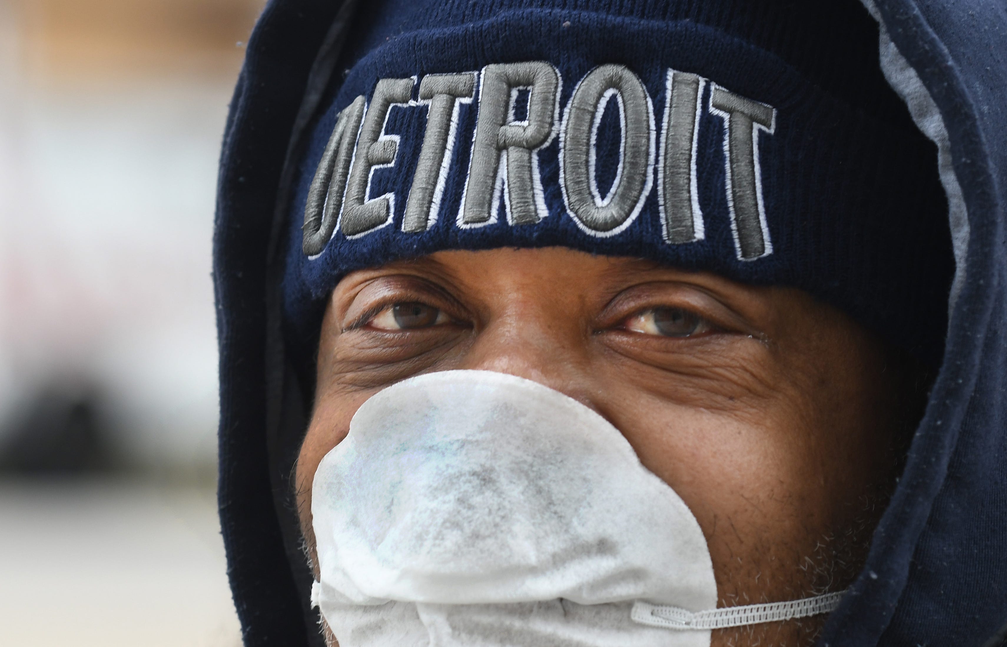 Luther Parks of Detroit waits for the bus March 30 in downtown Detroit, "Haven't been out in a couple days, it's quiet especially for a Monday." As for how he is doing, "They say I have to be smarter and I have to endure."