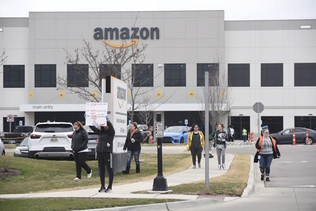 Workers walk off the job at the Amazon Fulfillment Center midday in Romulus Wednesday , April 1, 2020.