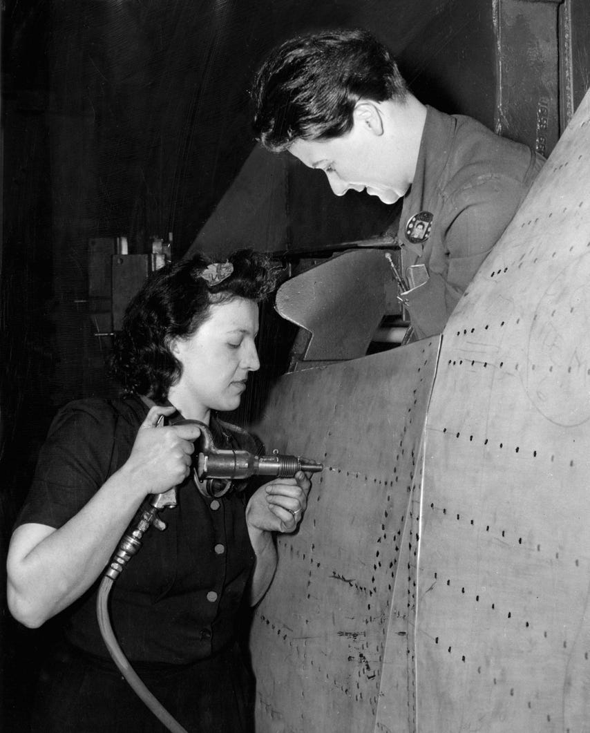 Mary Herrando and Grace Small rivet into the side a bomber at Willow Run bomber plant on January 30, 1943. Legions of "Rosie the Riveters" worked at the Detroit plants during WWII.