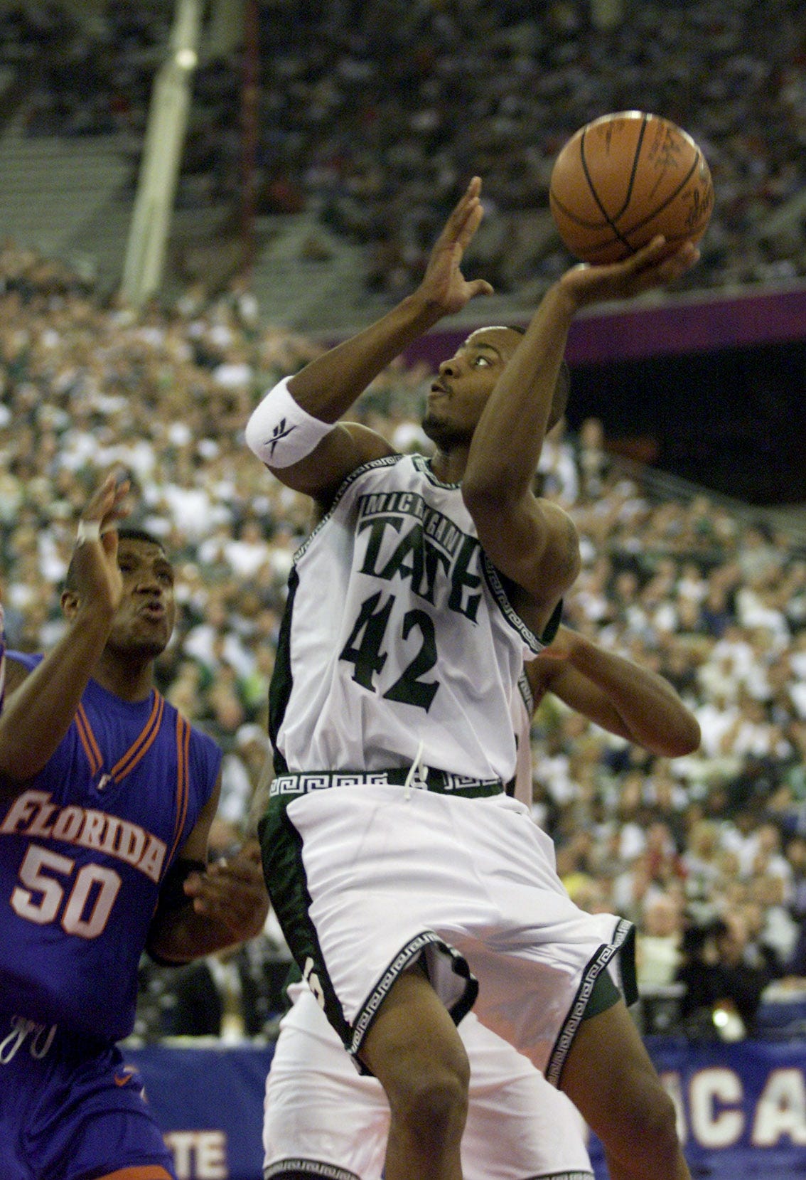 Michigan State ' s Morris Peterson drives to the basket on Florida ' s Udonis during 2000 NCAA national championship game at the RCA Dome in Indianapolis.