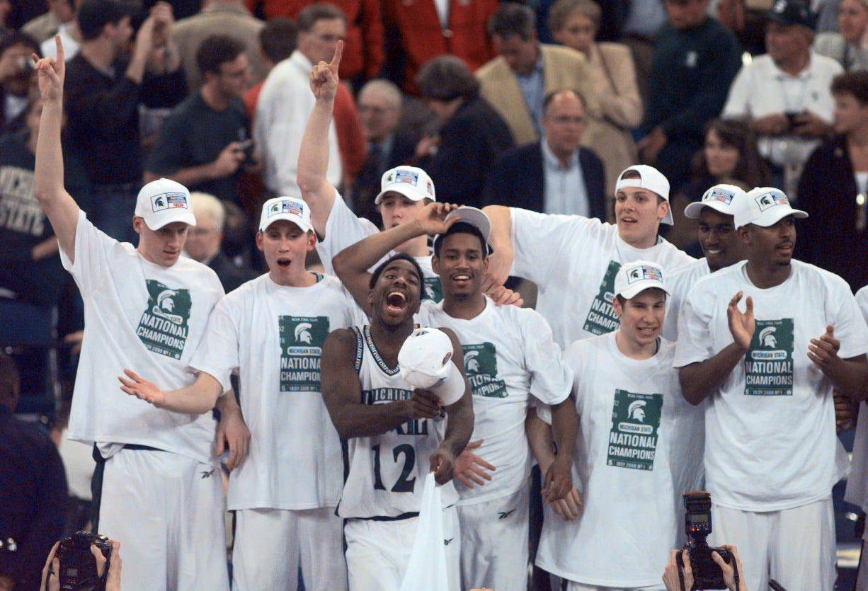 The Michigan State basketball team celebrates on risers while waiting to be awarded the championship trophy in 2000.