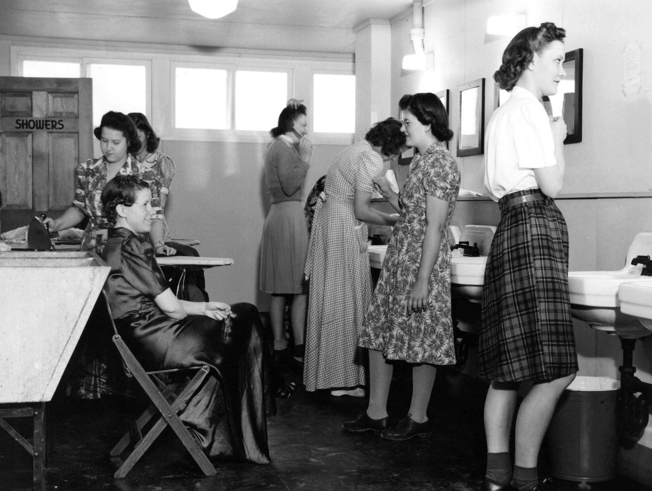 The washroom at Willow Run's West Lodge offered facilities for washing and ironing clothes. The women came from varied backgrounds: They were teachers, waitresses, housewives. They worked on the line doing riveting, light assembly or as inspectors or trainers.