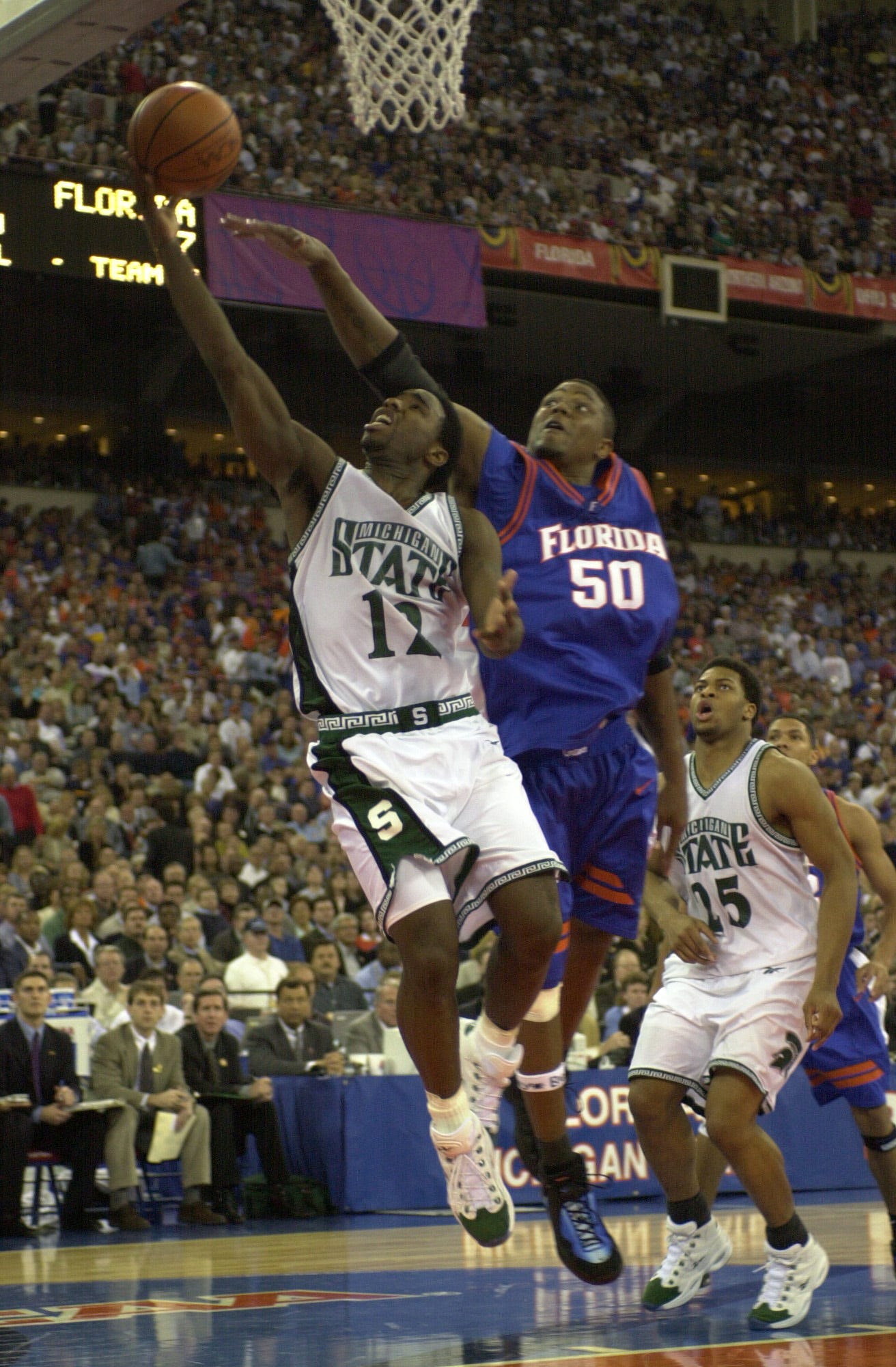 Michigan State ' s Mateen Cleaves drives to the hoop for a layup as Florida ' s Udonis Haslem tries to block the ball from behind in the 2000 NCAA national title game.
