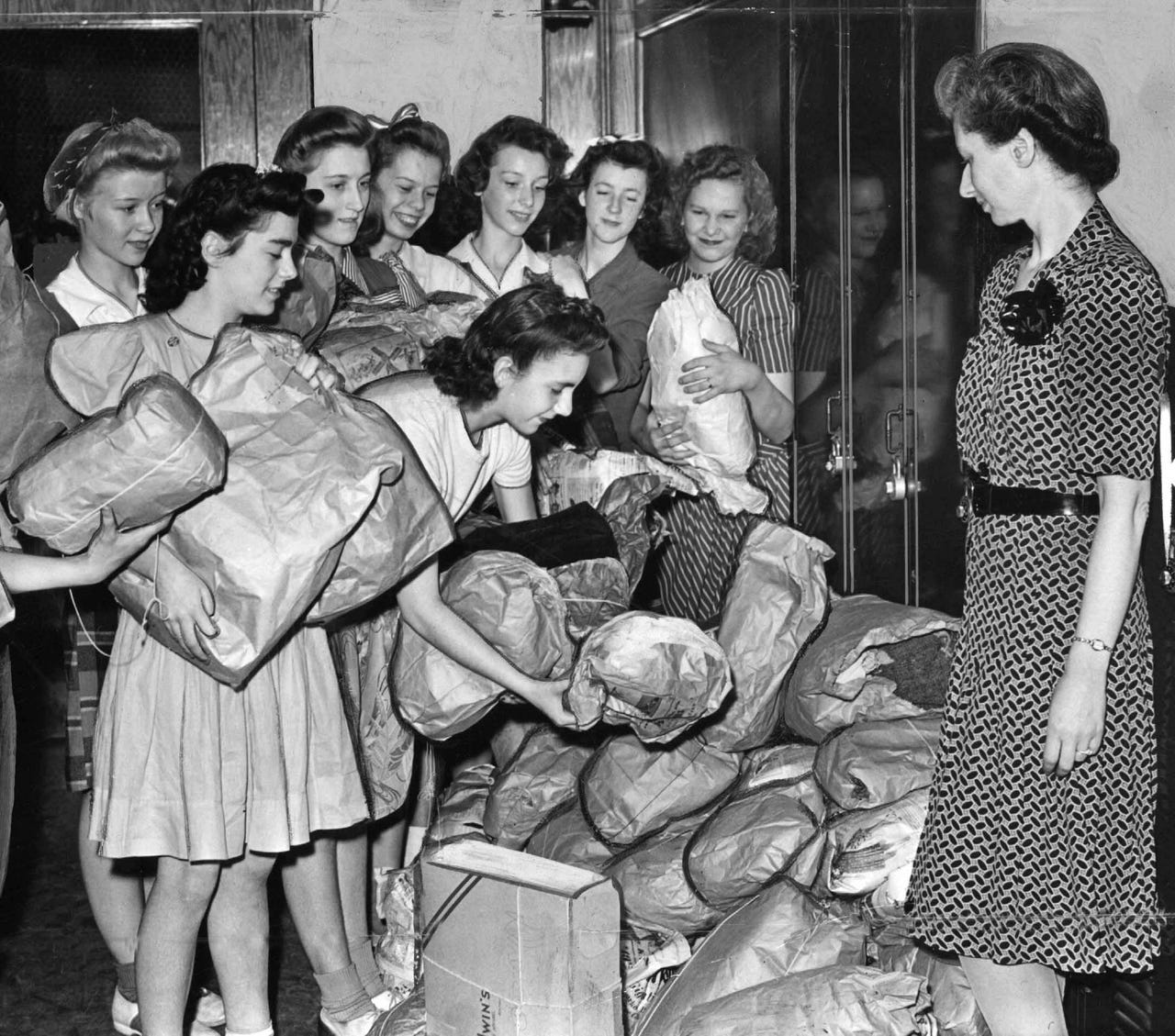 Students from the Andrew Jackson School in Detroit pile up their salvage efforts for clothing, rubber, iron and paper for the war effort in May 1942.