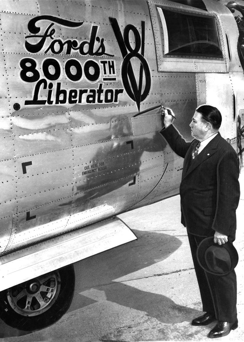 M.L. Bricker puts the finishing touch on the 8,000th bomber to come of the assembly line at the Ford Motor Company, March 20, 1945.
