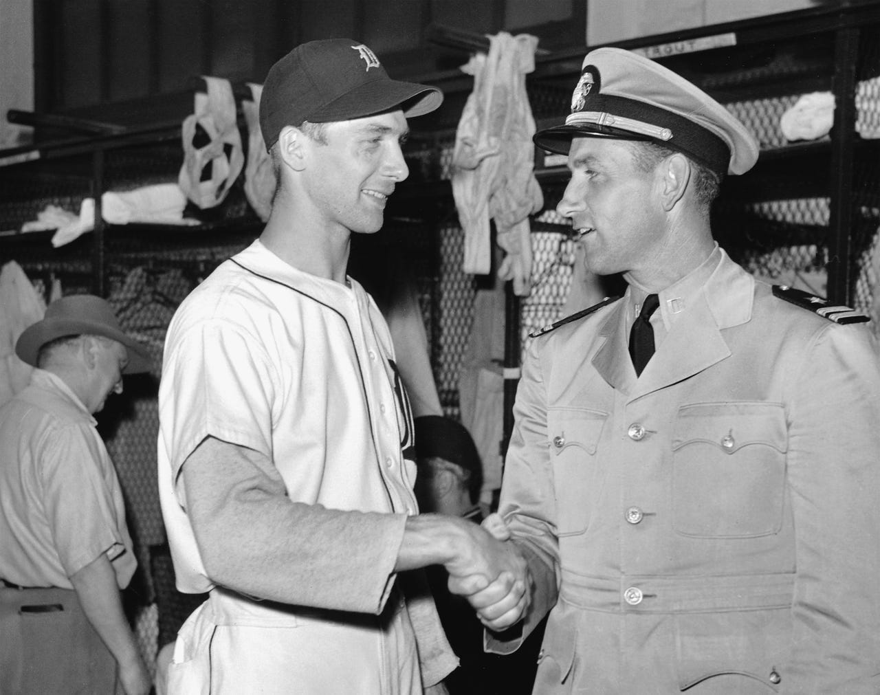 Tigers rookie Hal Newhouser and retired great Charlie Gehringer meet in the locker room at Briggs Stadium on Aug. 27, 1941. Newhouser had intended to join the service to fight for his country during World War II and was to take his oath on the Briggs Stadium mound before a game. However, a heart murmur was detected during his physical, so he remained with the Tigers.