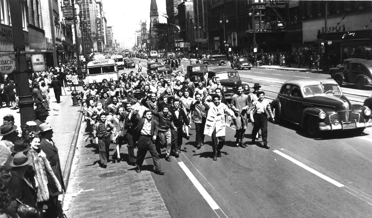 A crowd of high school students parades on Woodward to celebrate the end of the war in Europe in May 1945.
