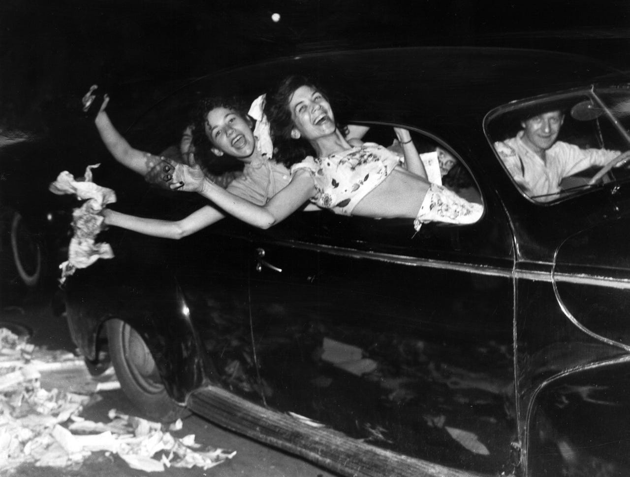 Teenagers celebrate the end of the war and the victory over Japan with an early car cruise.