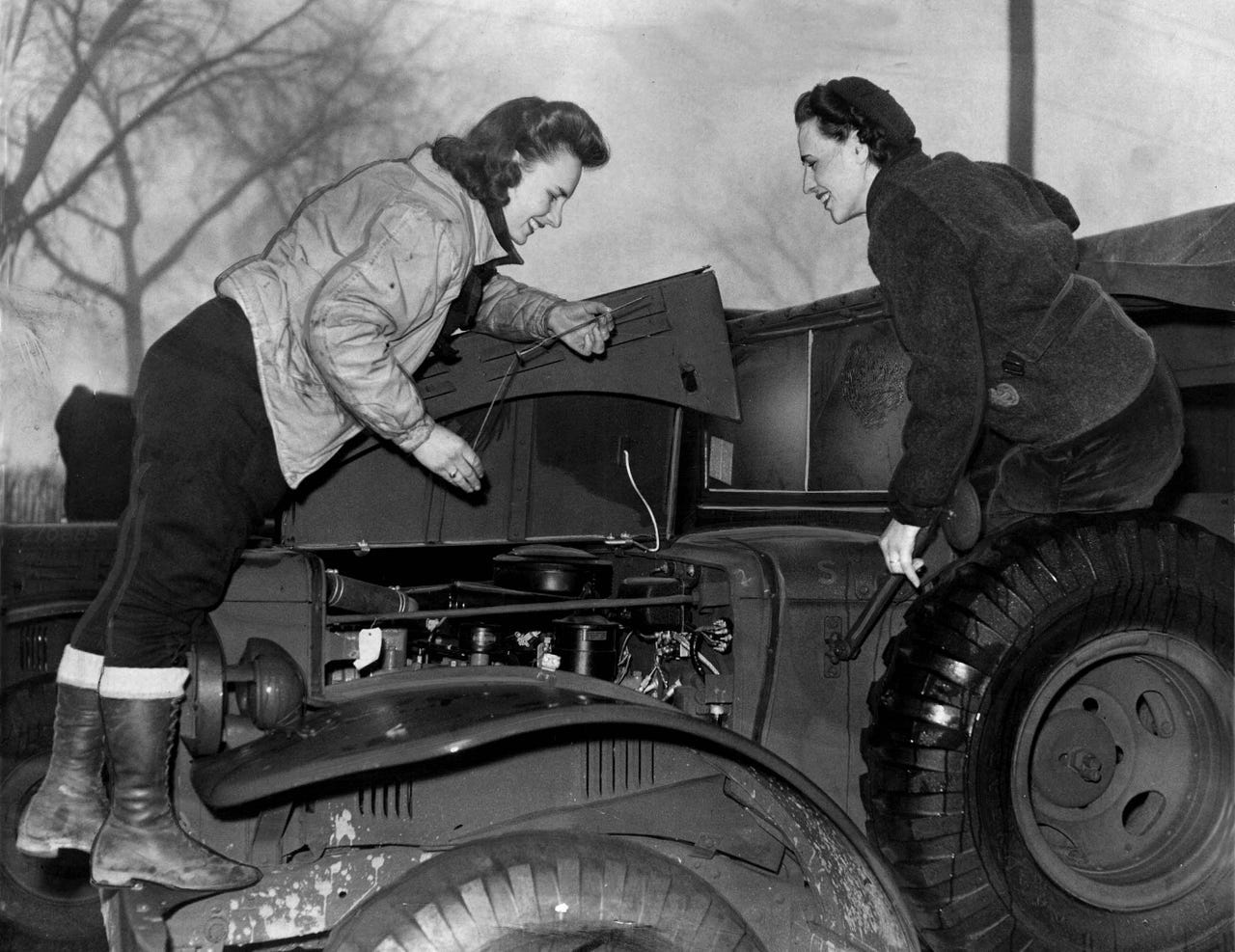 Ruth Markovich and Anna Plagens were drivers for the U.S. Army in November 1942. The women checked the oil on their Jeep and did their own minor repairs while on convoy.