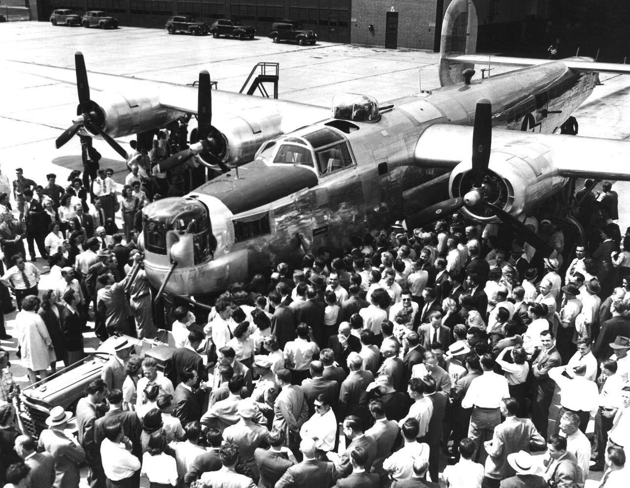 The last bomber rolled off the line June 25, 1945. The plane was to be christened "The Henry Ford," but Ford asked that his name be taken off and the plane be named after the workers who had built it. Here it's being autographed by the last remaining workers at Willow Run.