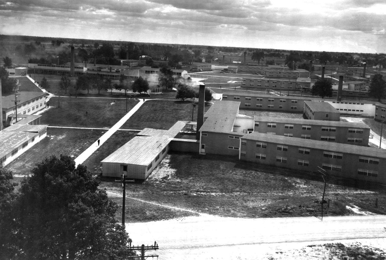 A 1944 view of the Willow Run Lodge Dormitories. In the left background are the theatre, the cafeteria and community center. Willow Lodge was a dormitory for single workers four miles from the plant, built to hold 3,000 workers. Rooms were $5.00 per week. An initial experiment to house the sexes together, with men and women on alternating floors, was quickly ended after "gamblers and fast girls quickly moved in," according to a Detroit News report.