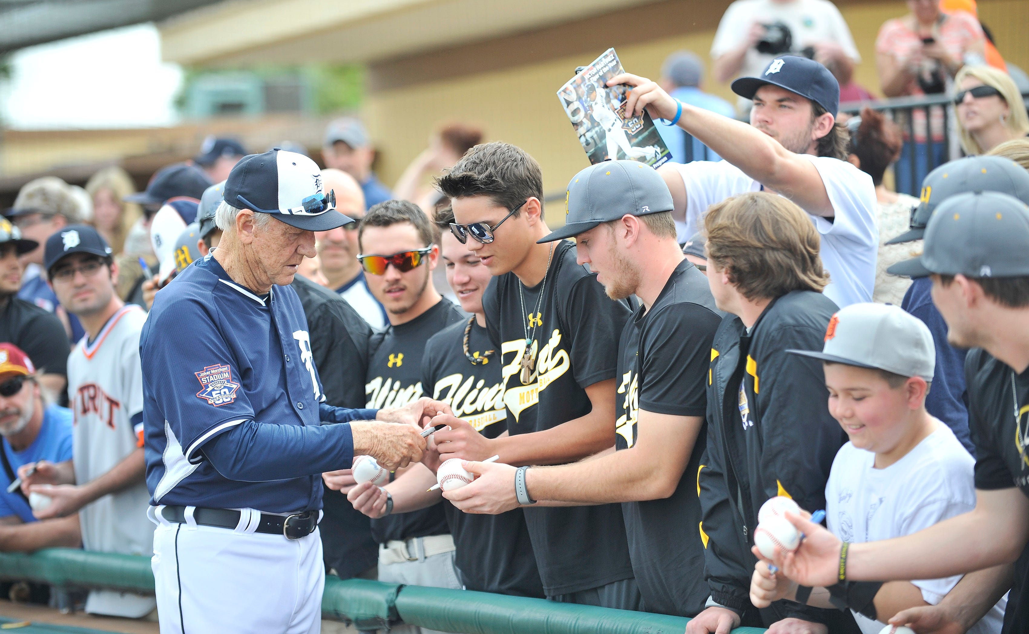 Tigers legend Al Kaline signs autographs for players from Flint Mott baseball team during batting practice before a game against the Toronto Blue Jays at Joker Marchant Stadium in Lakeland, Fla. on March 9, 2015.