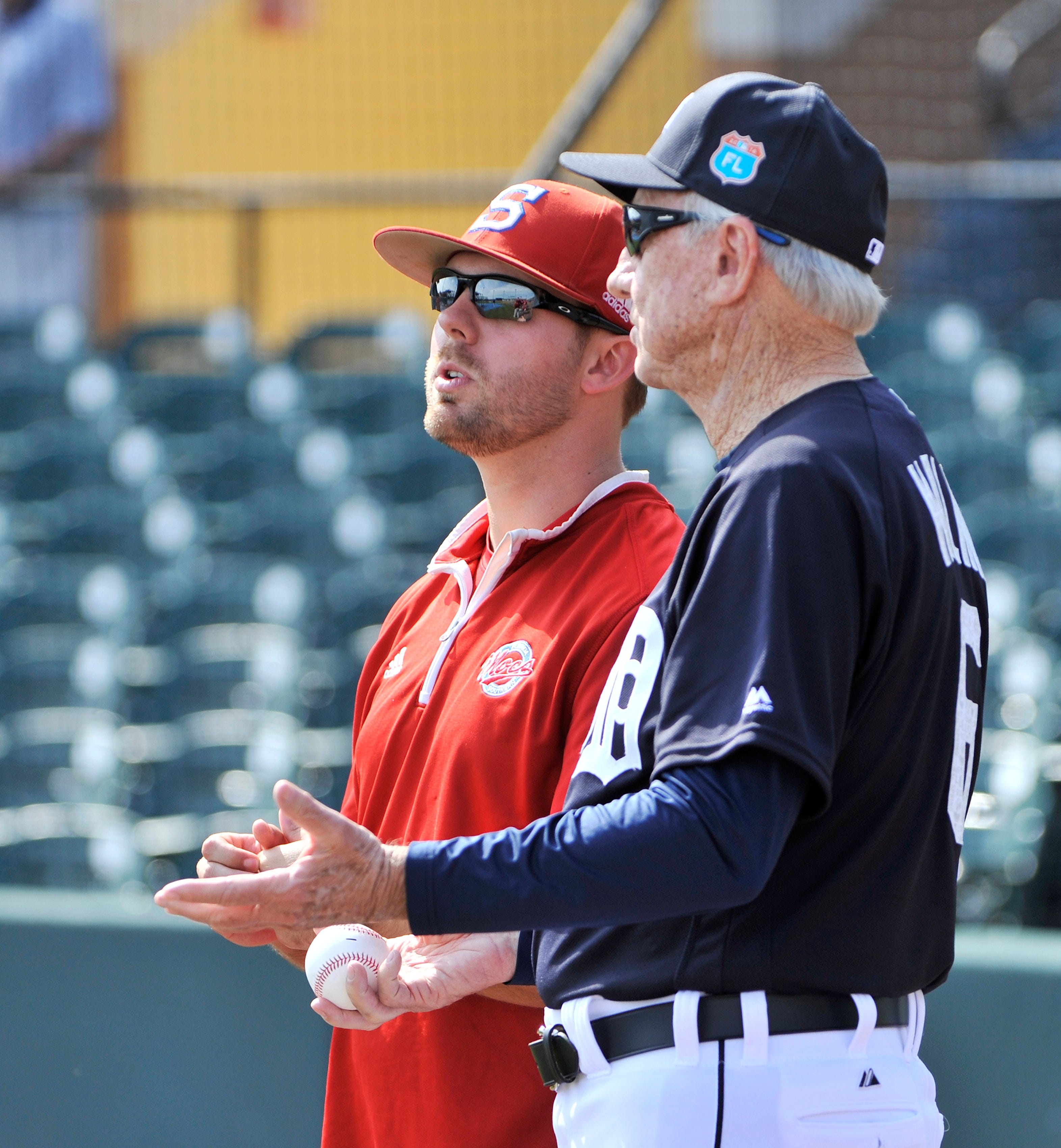 Florida Southern assistant coach Colin Kaline, left, talks with his grandfather, Al Kaline, during batting practice before a spring training exhibition game between the Detroit Tigers and Florida Southern College at Joker Marchant Stadium in Lakeland, Fla. on Feb. 29, 2016.