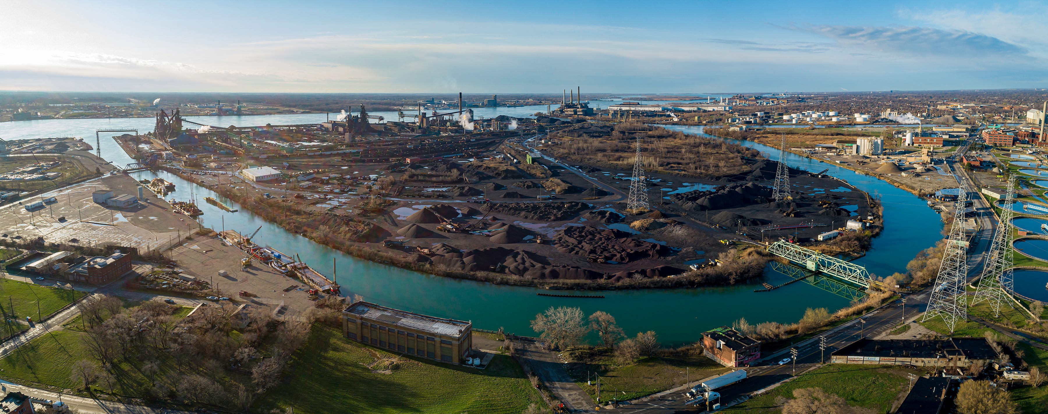 The bridge at the upper left in this recent drone photograph doubles as a railroad trestle and is the main entrance to Great Lakes Works on Zug Island. The two tall structures beyond the bridge are the A and B furnaces, idled respectively around 2000 and last summer. The similar dark tower to their right is blast furnace D, which may have produced its last iron in late March. The bridge at the lower right, known as the Gap Gate, is rarely used.
