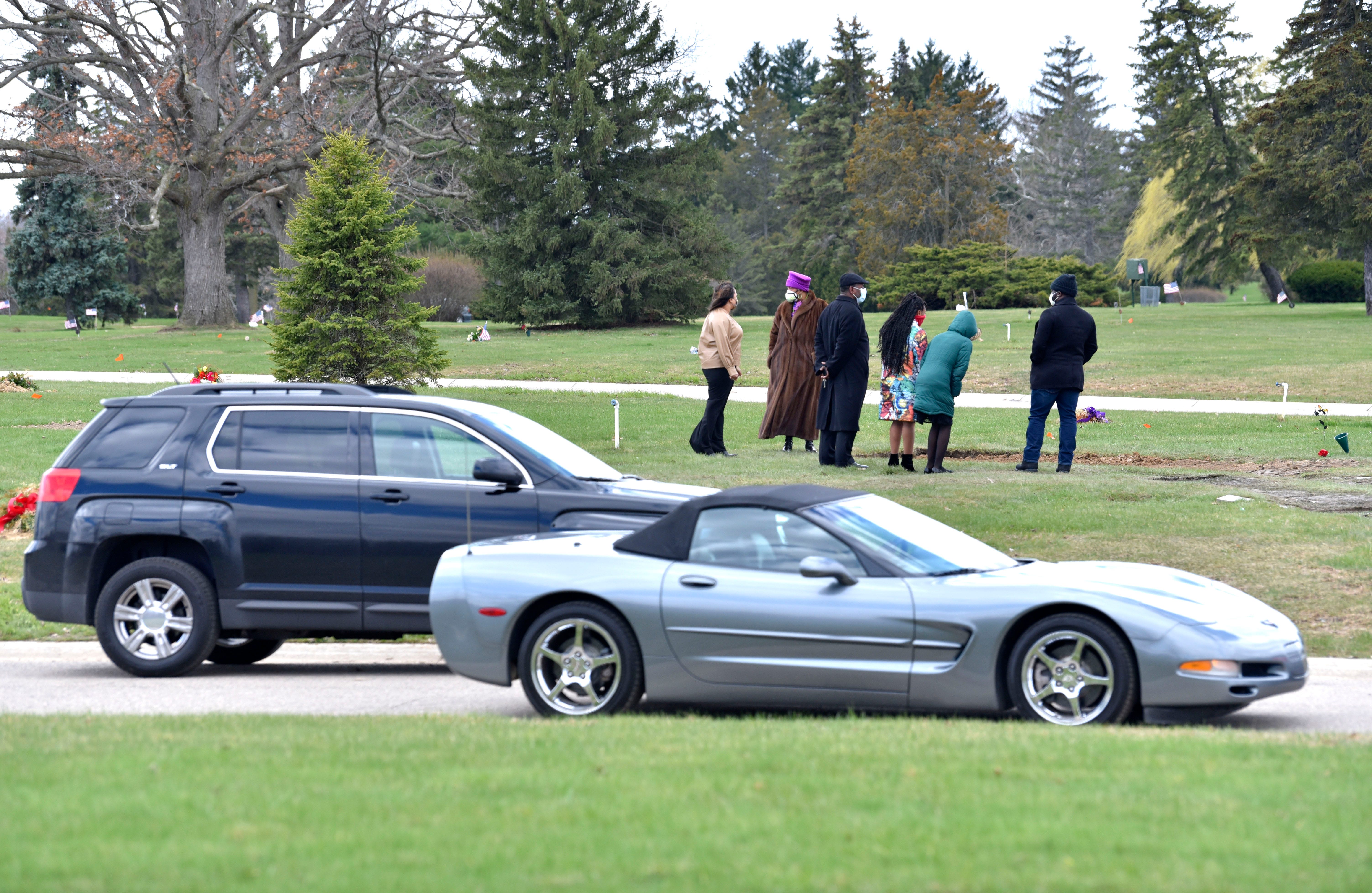 Loved ones pay respects from their vehicles at they pass the gravesites of Freddie Lee Brown Jr. and Freddie Lee Brown III.