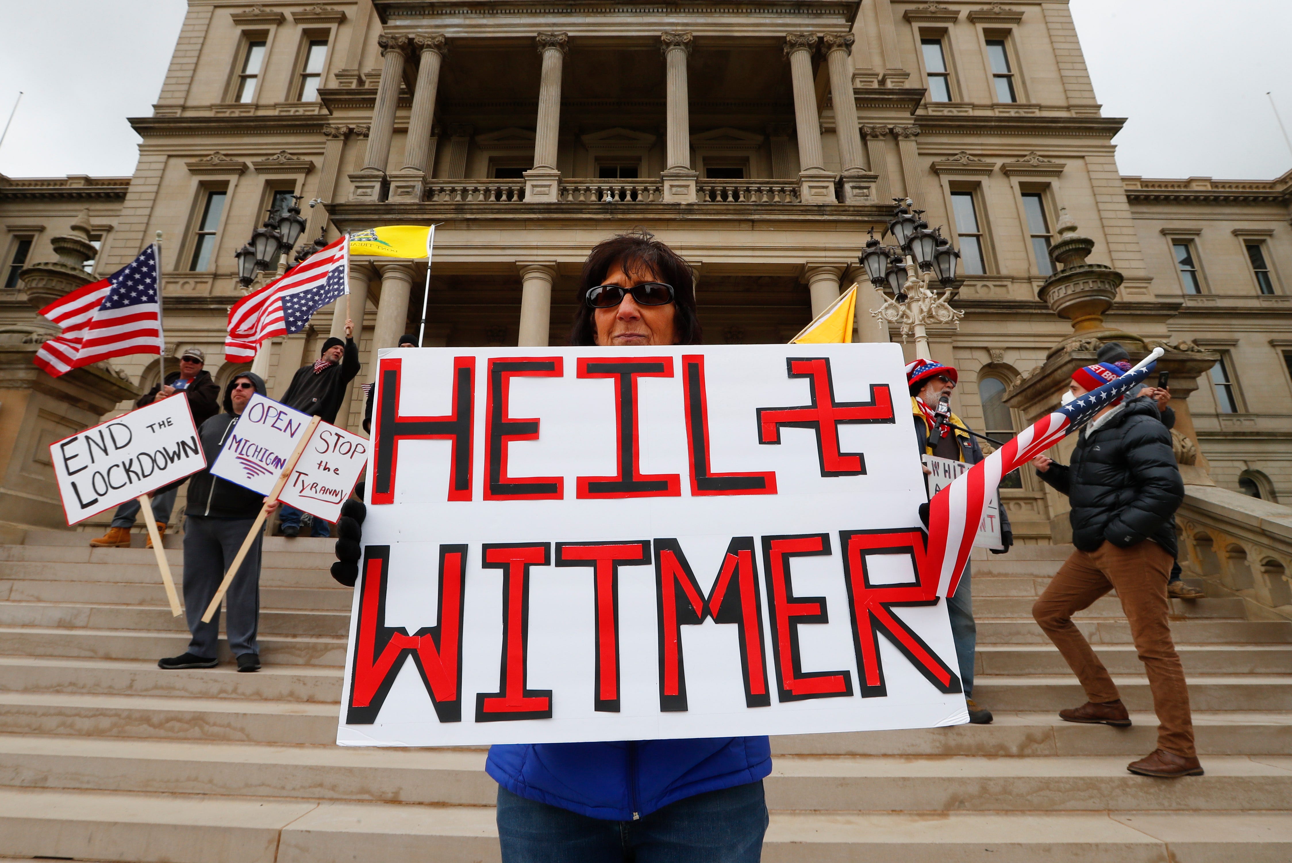 Dawn Perreca protests in Lansing on Wednesday.