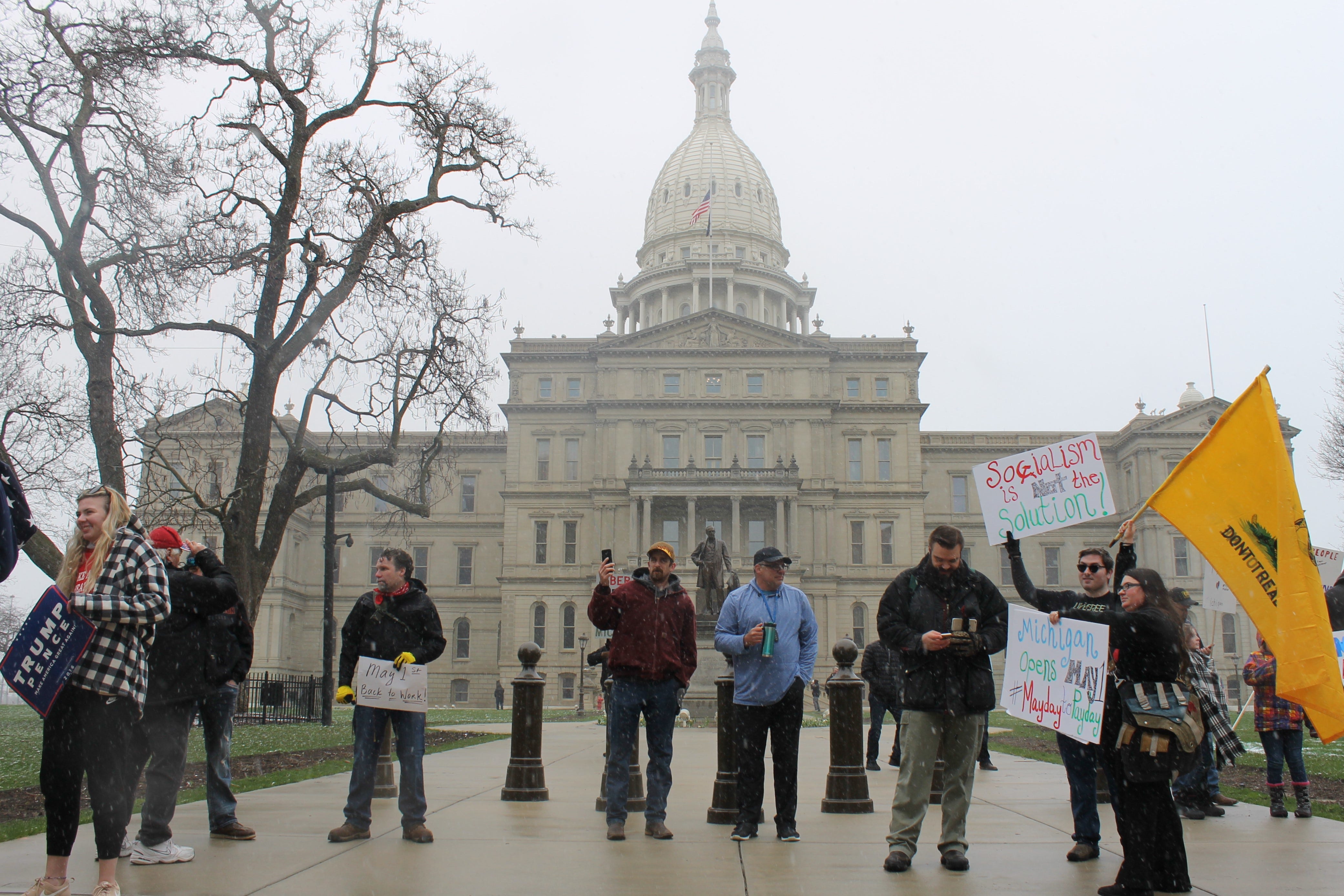 Protesters gather in front of the Michigan Capitol on Wednesday, April 15, 2020, to protest Gov. Gretchen Whitmer's stay-at-home order. People are supposed to remain six feet apart to stem the spread of the virus.