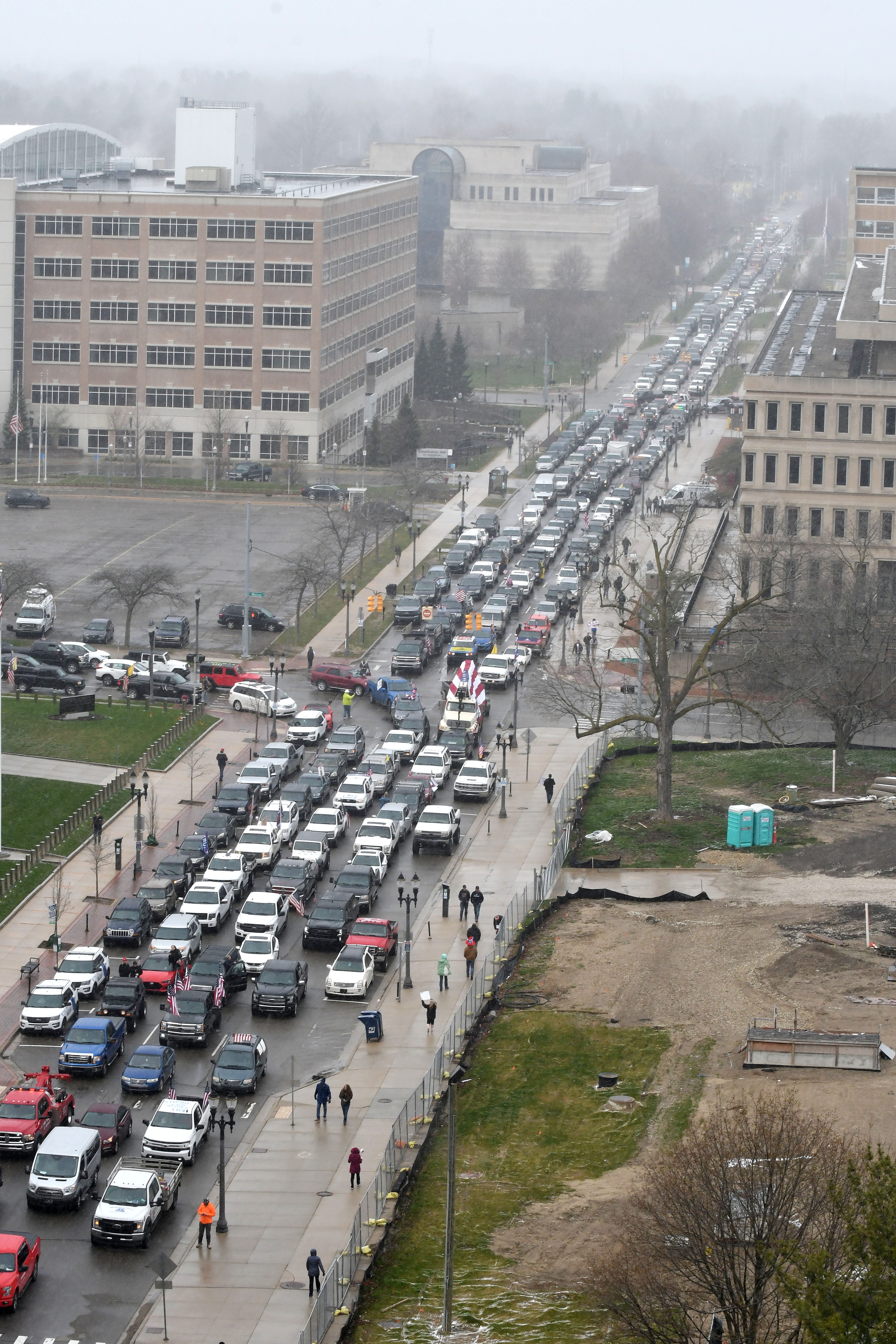 Cars aren ' t moving at the corner of West Allegan Street and North Capitol Avenue as protestors surround the state Capitol during Operation Gridlock.