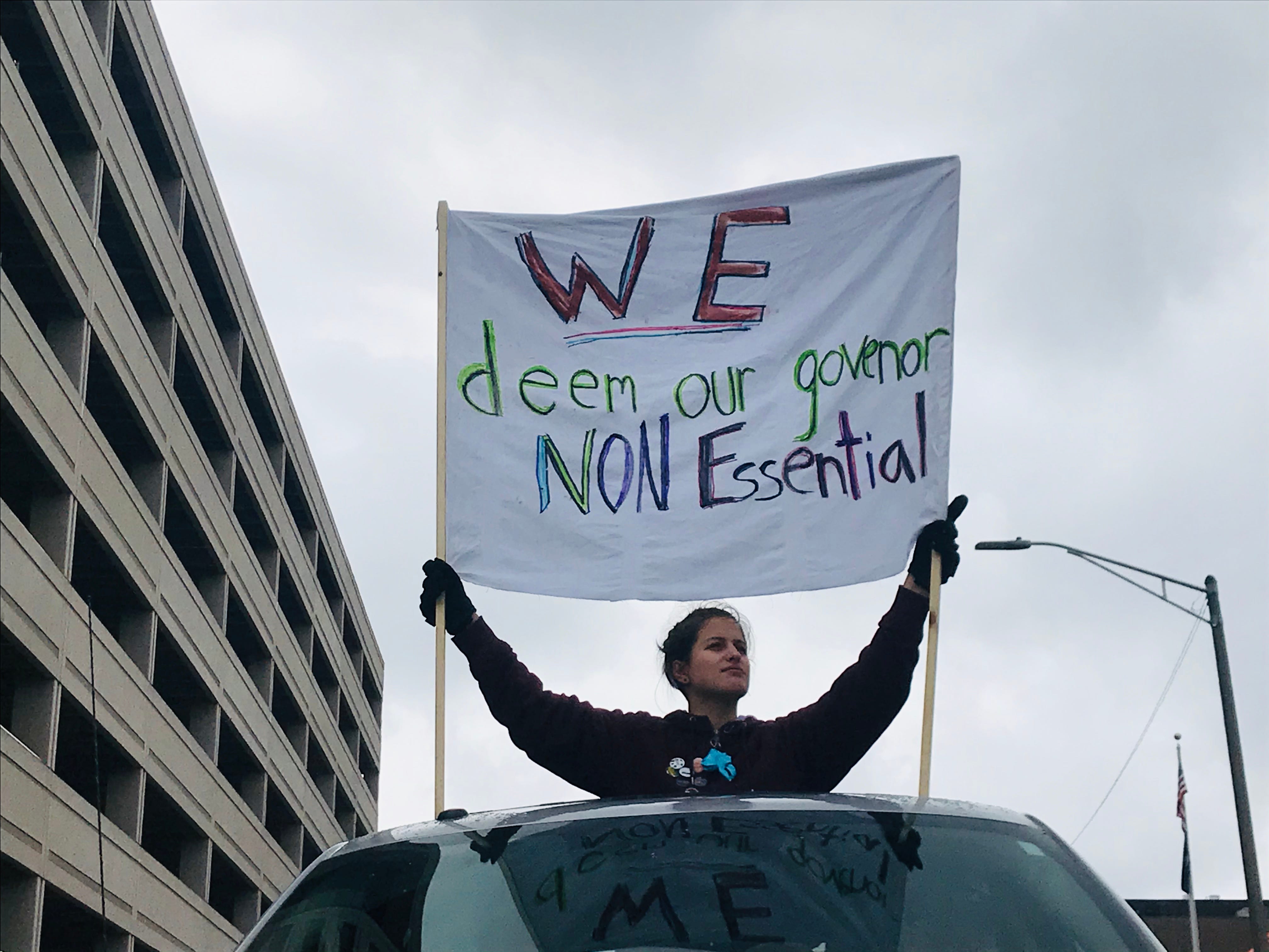 An unnamed protester holds a sign against Gov. Gretchen Whitmer during a demonstration on Wednesday, April 15, 2020. Hundreds of protesters gathered at the Capitol to voice their frustration with Whitmer's stay-at-home order.