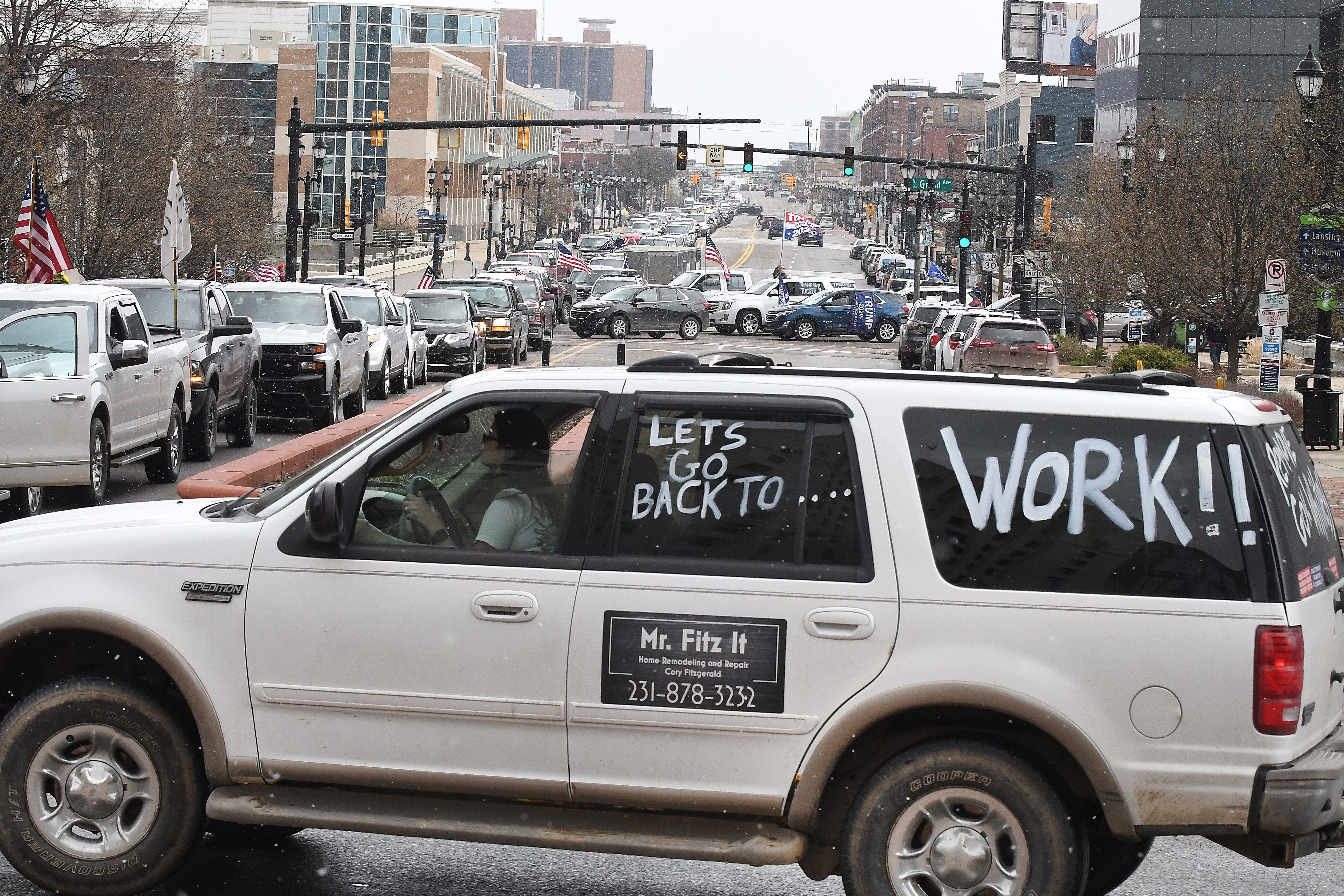 People in vehicles protest the Governor's stay home order during "Operation Gridlock" in Lansing Wedesday.