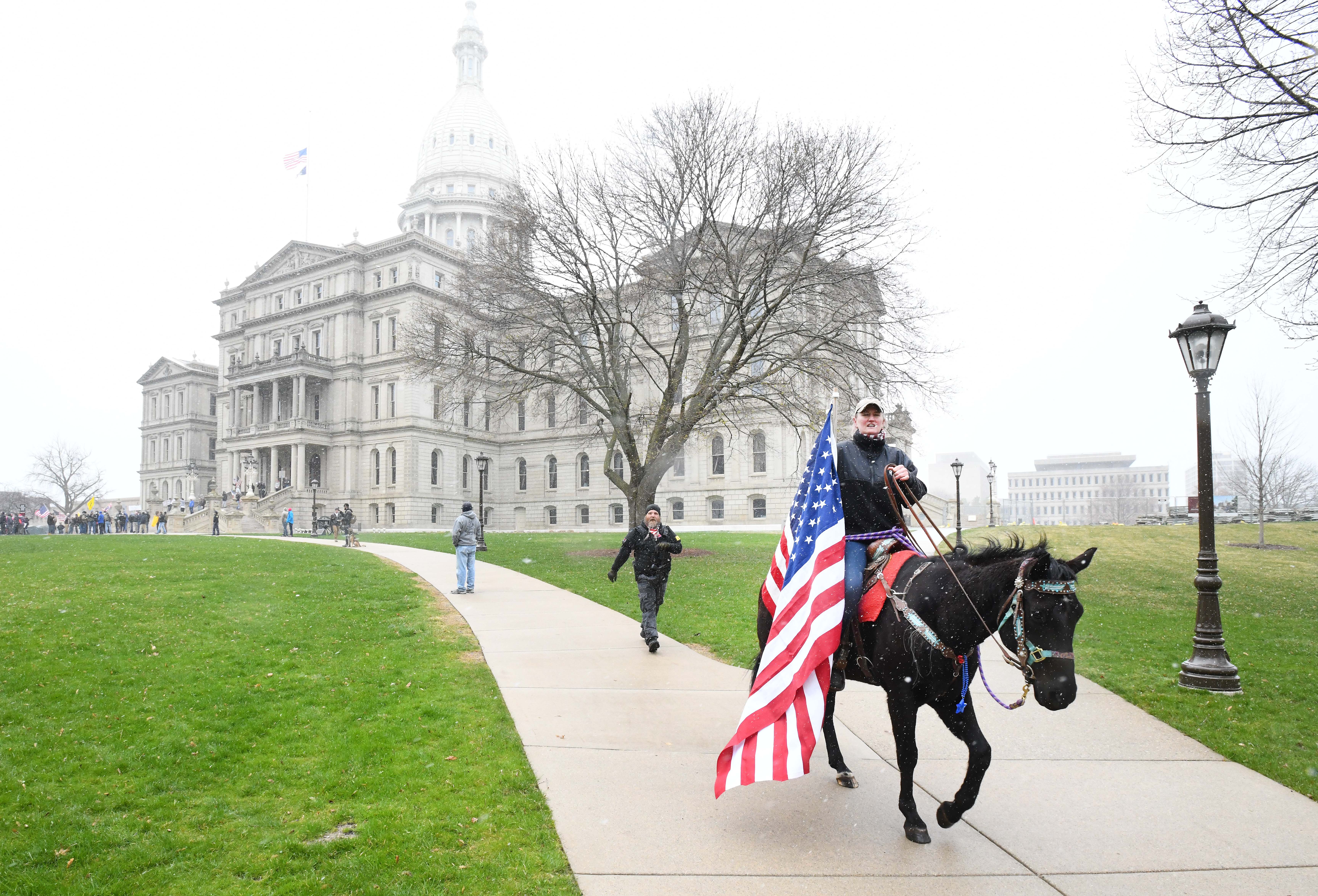 Stacy Bailey rides her horse in front of the state Capitol during Operation Gridlock.