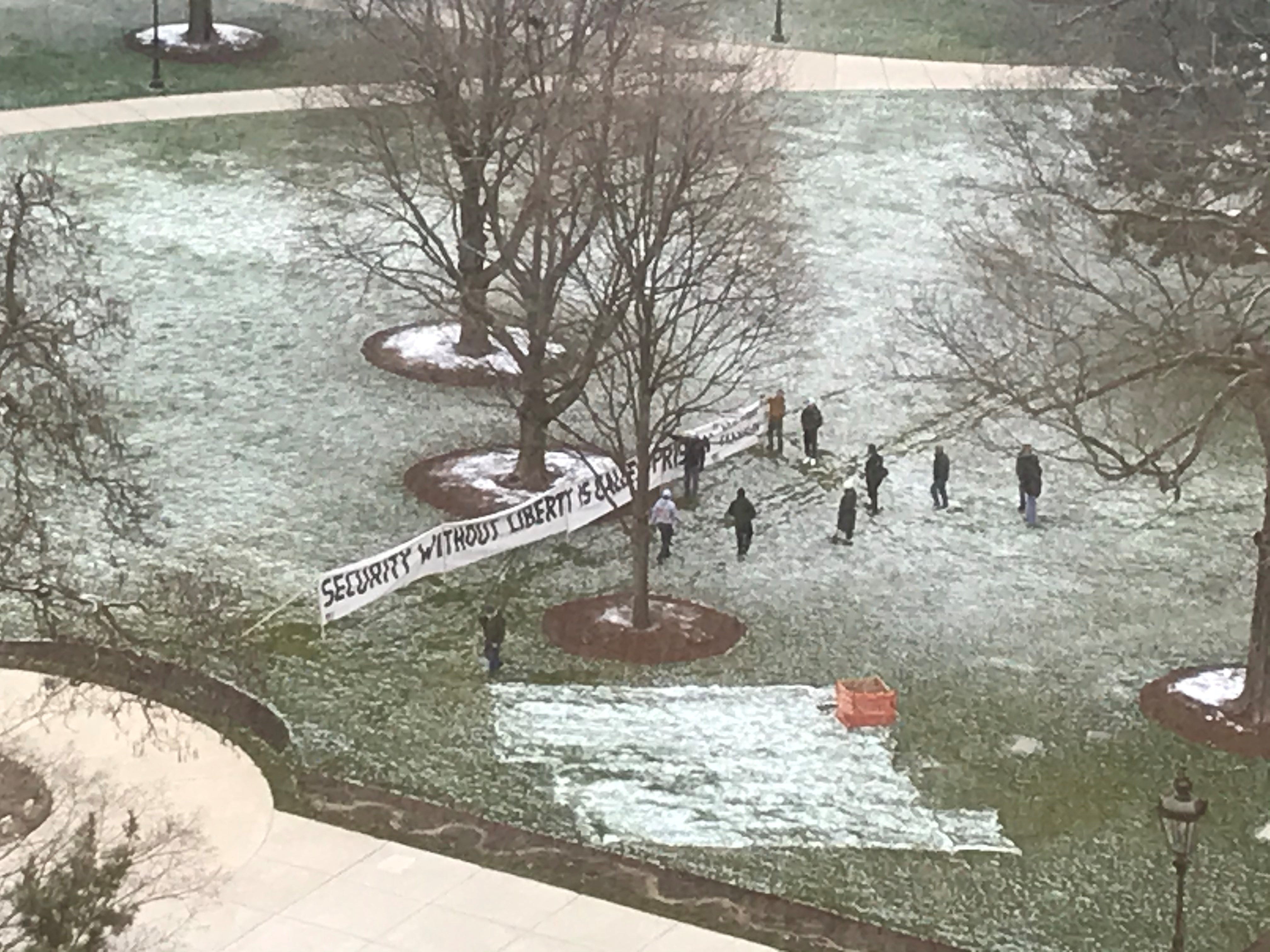 Protesters participating in the Operation Gridlock rally around the Michigan Capitol set up a sign saying "Security Without Liberty Is Called Prison" on Wednesday, April 15, 2020.