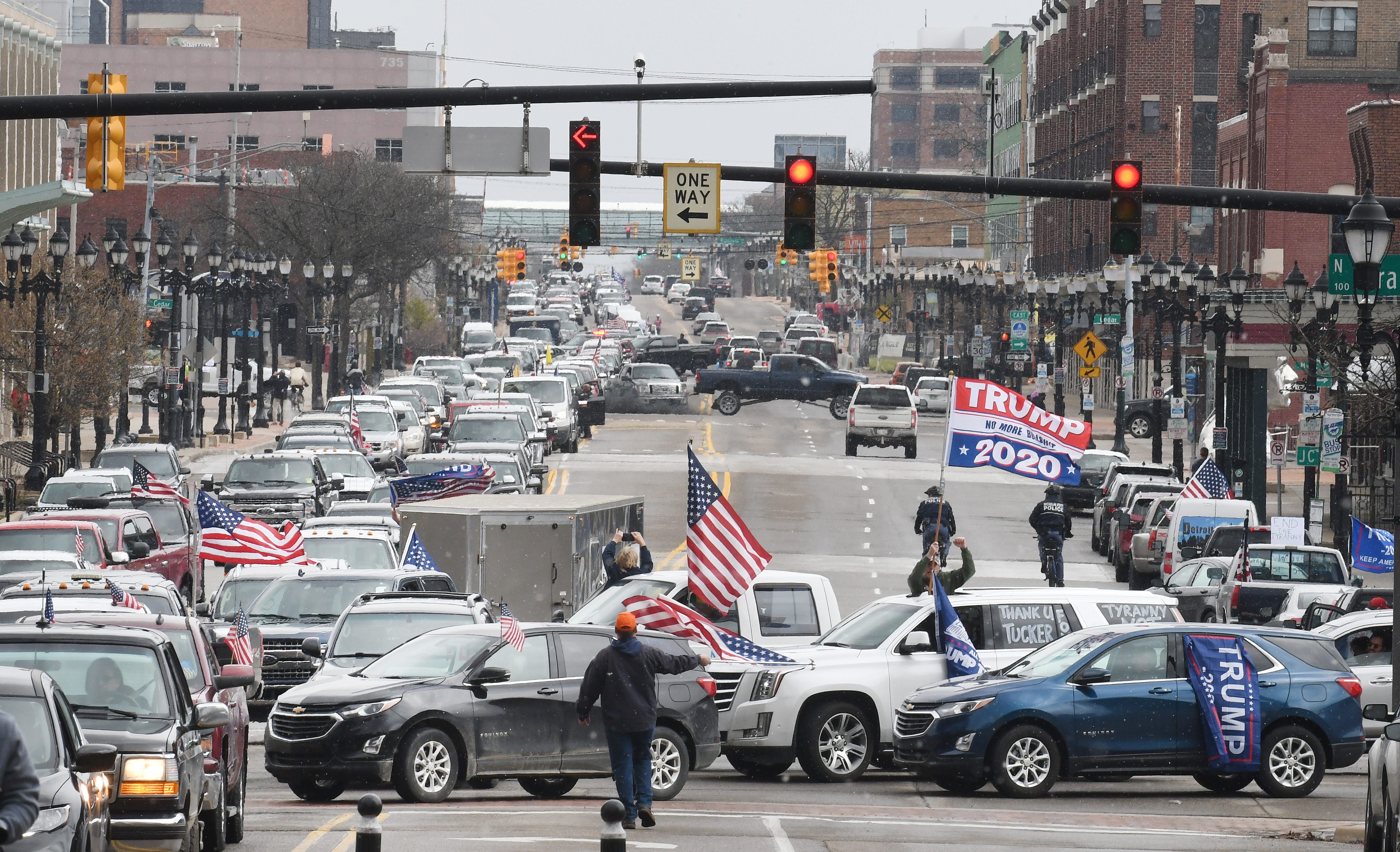 People protesting Gov. Gretchen Whitmer ' s stay-home order clog Michigan Avenue from after Interstate 127 to the state Capitol on Wednesday.