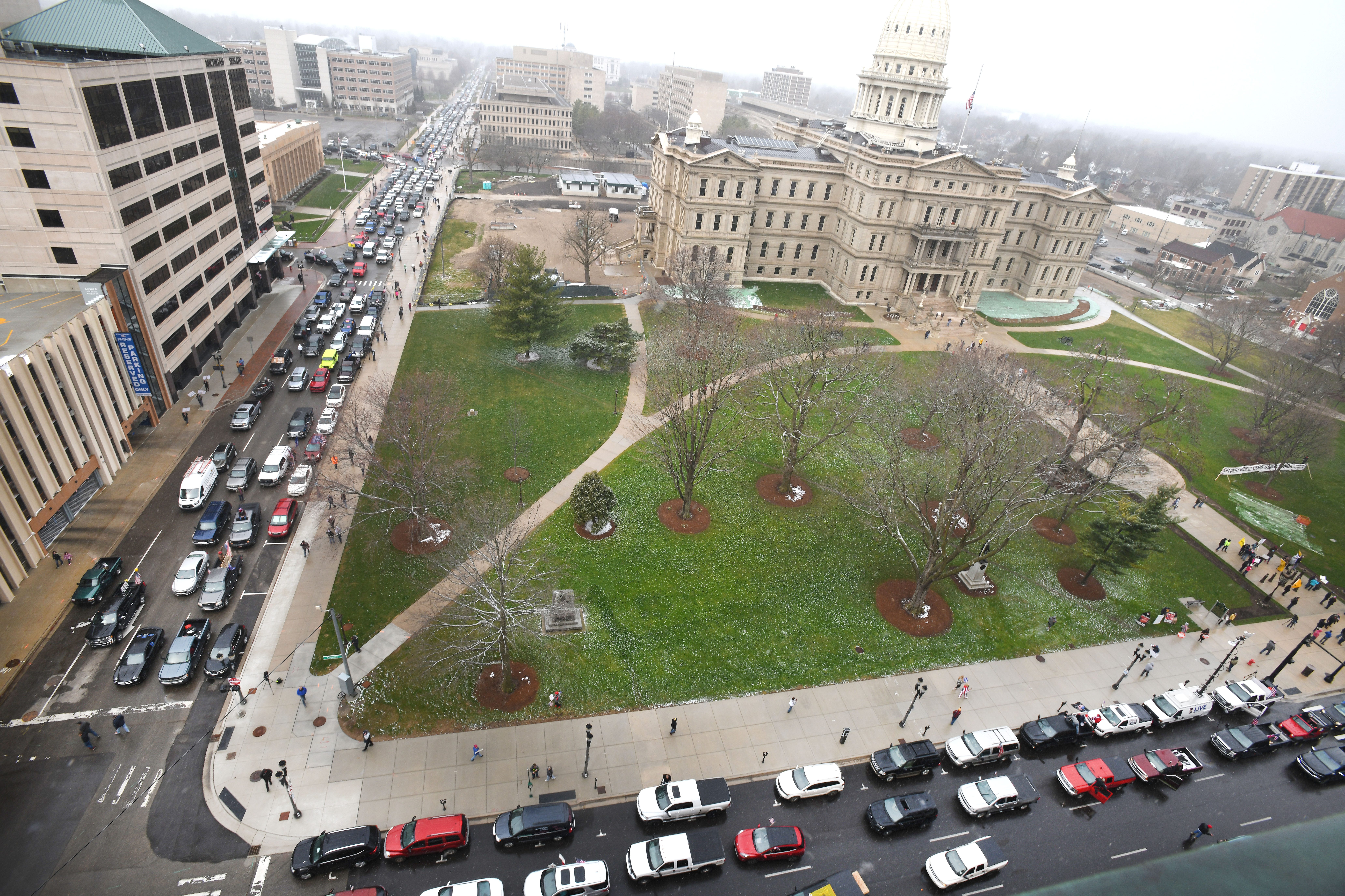 Cars aren ' t moving at the corner of West Allegan Street and North Capitol Avenue in Lansing as people protest some of Gov. Gretchen Whitmer ' s new executive orders, on April 15, 2020.