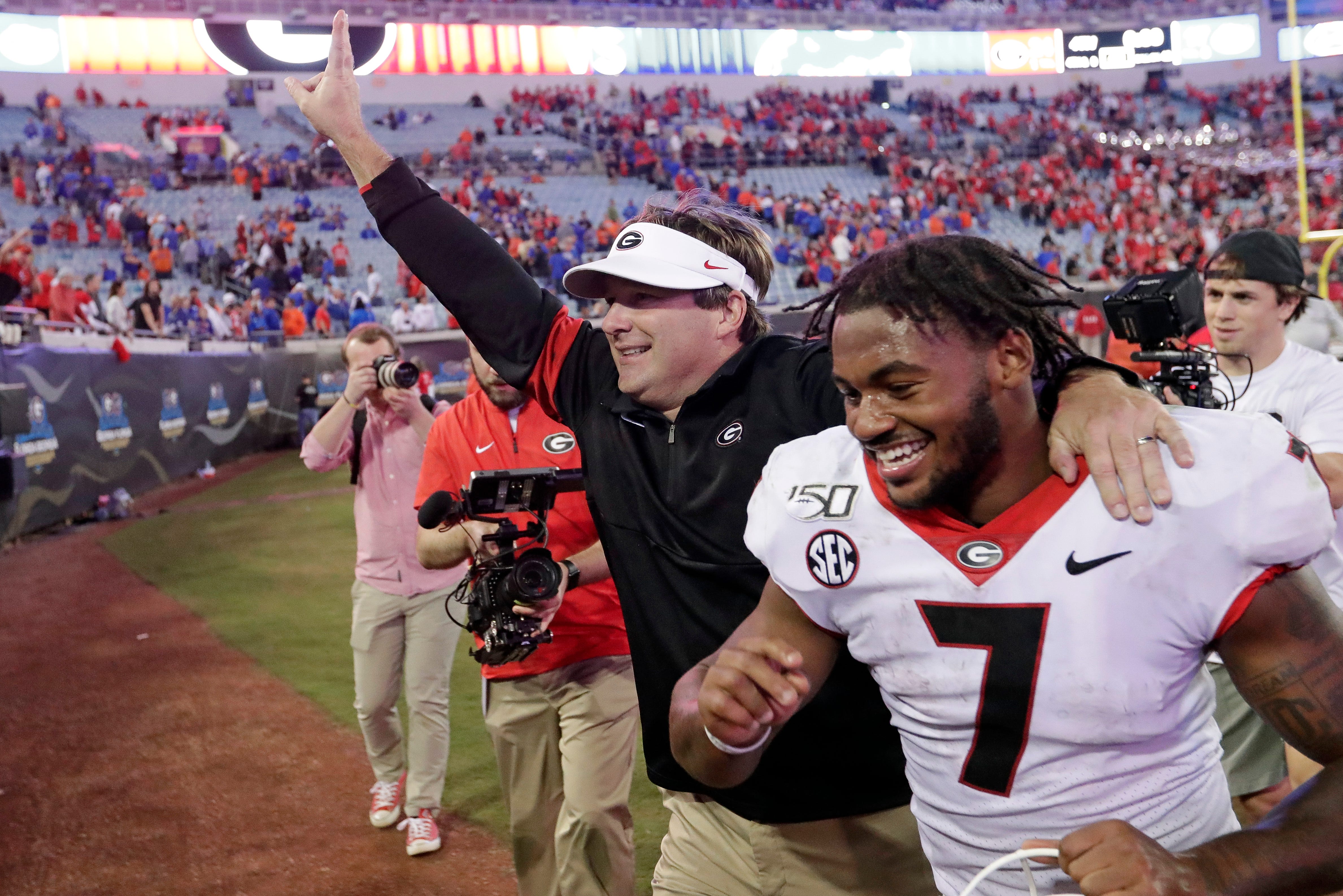 Georgia head coach Kirby Smart and running back D'Andre Swift run off the field celebrating after defeating Florida in 2019.