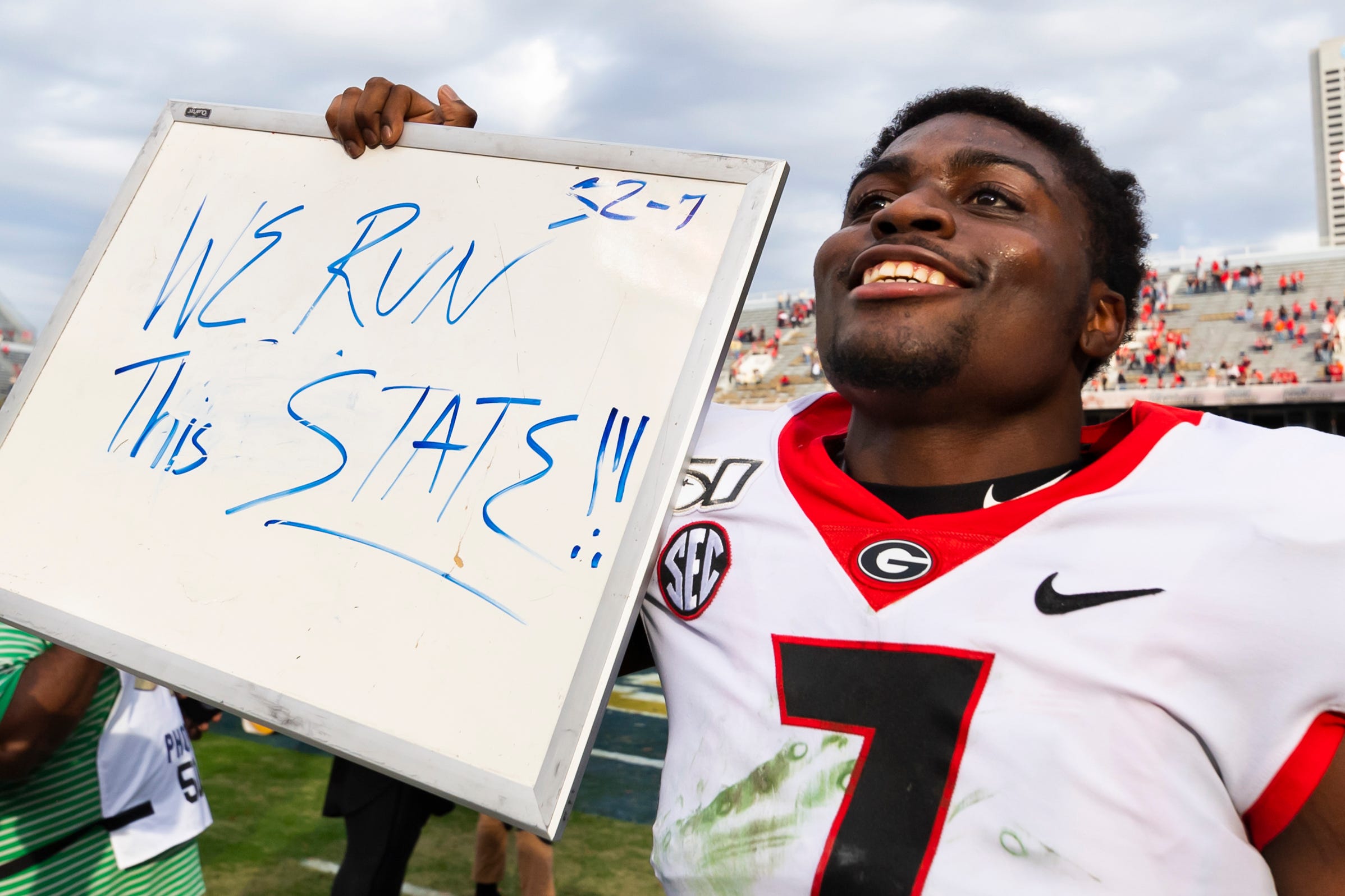 Georgia running back D'Andre Swift holds up a message for fans as he leaves the field after a win over Georgia Tech in 2019.