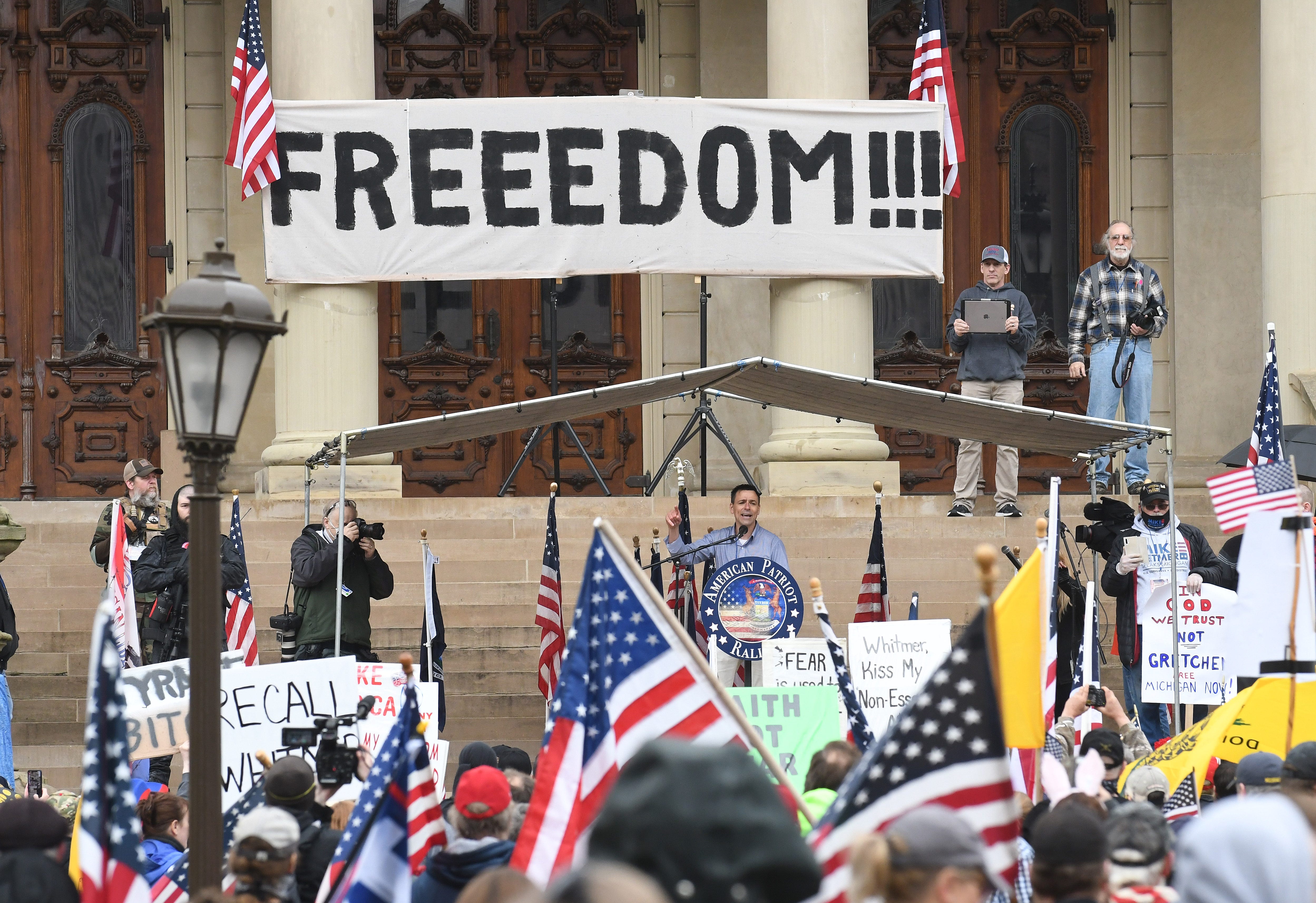 Protesters on the steps of the Michigan Capitol during the " American Patriot Rally,: in protest of Gov. Gretchen Whitmer ' s coronavirus policies, in Lansing on April 30, 2020.