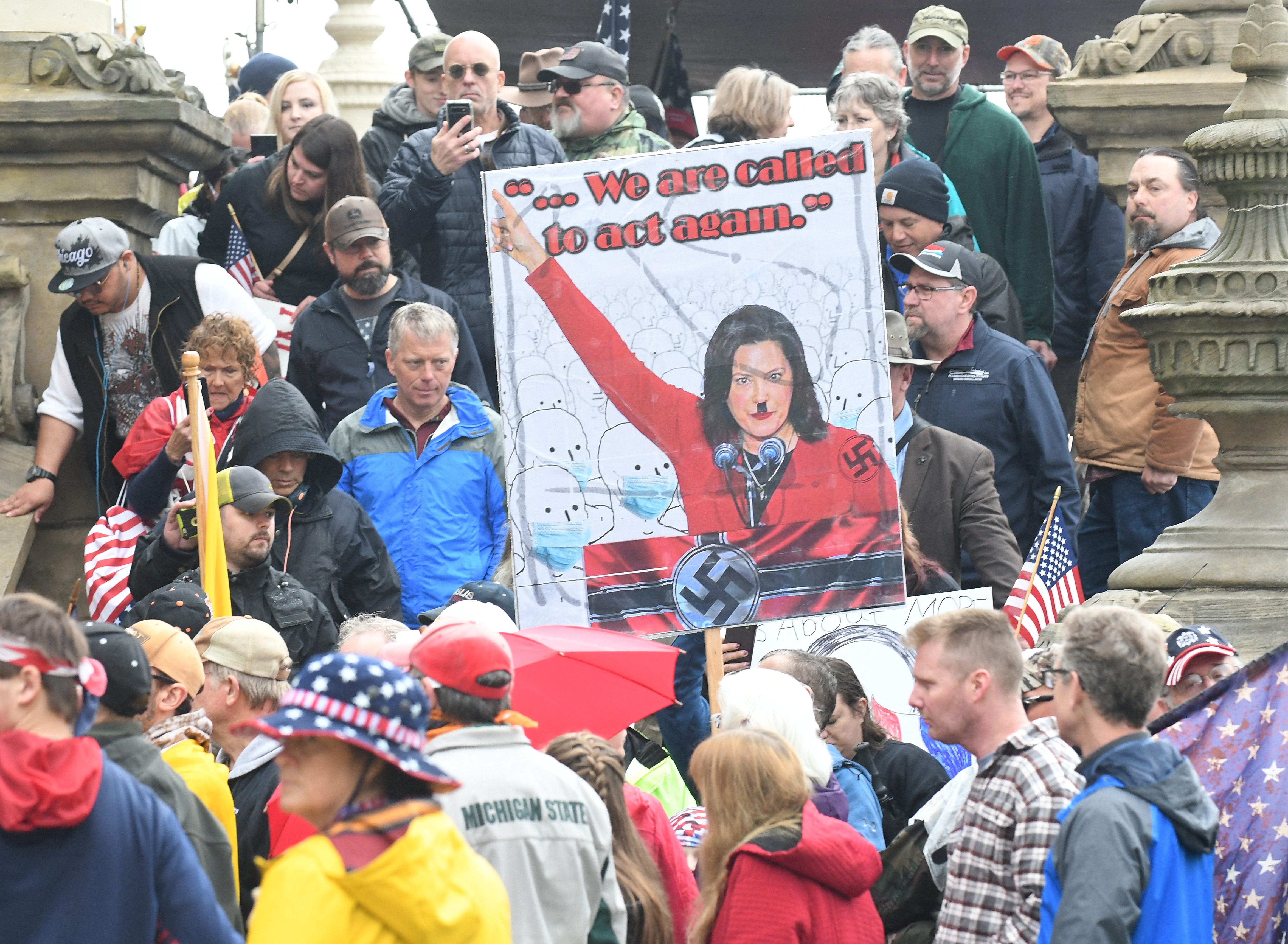 Protesters make their way down the steps of the Michigan Capitol after the " American Patriot Rally " in Lansing on April 30, 2020.