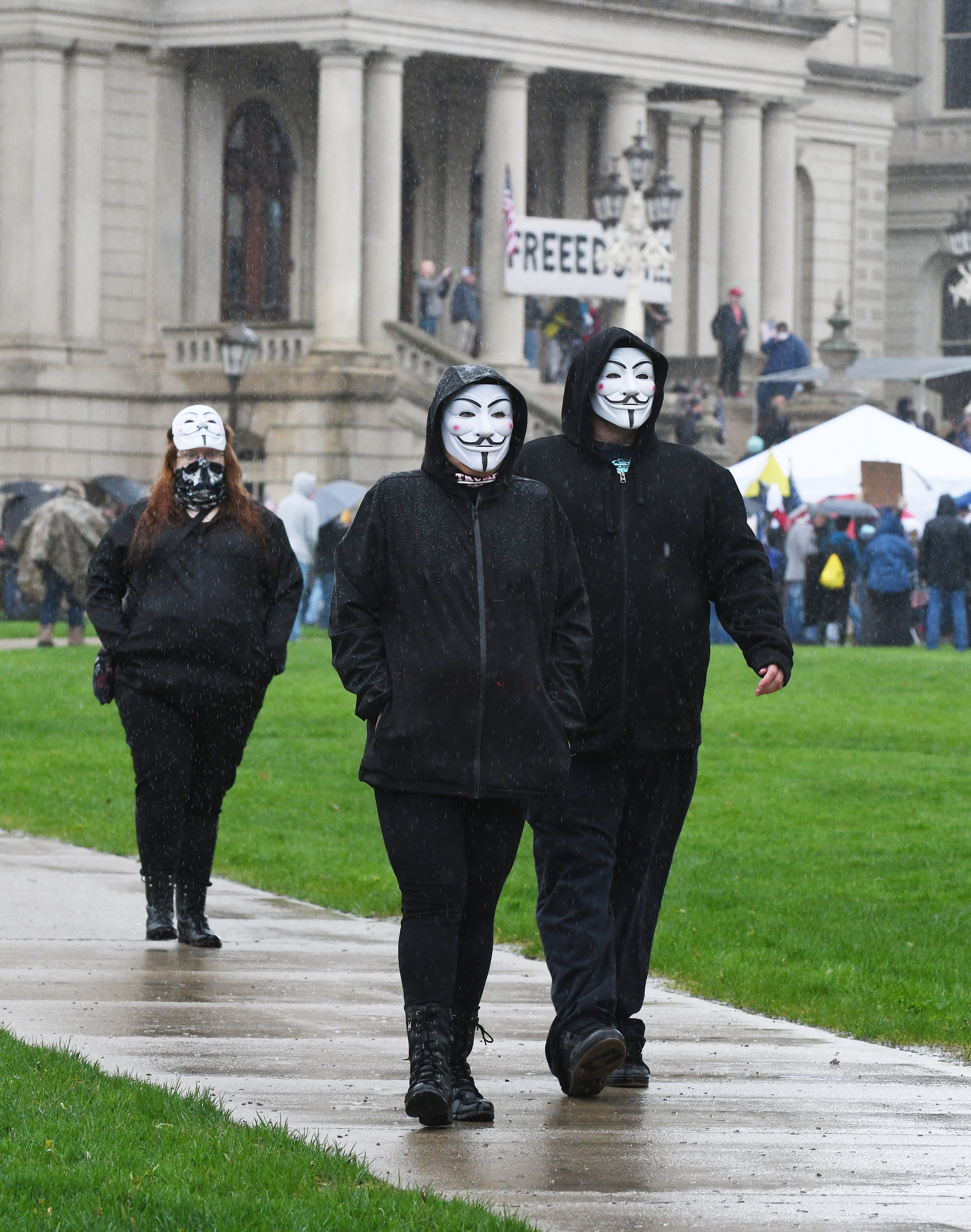 Masked protesters during the " American Patriot Rally, " in protest of Gov. Gretchen Whitmer ' s coronavirus policies, near the Michigan Capitol in Lansing on April 30, 2020.