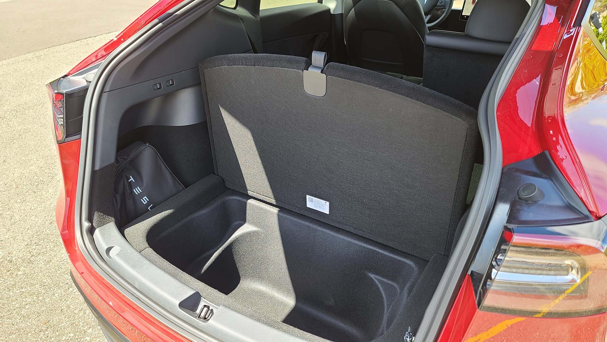 Sub-trunk storage in the Tesla Model Y may also be used for a rear-facing, third-row seat.
