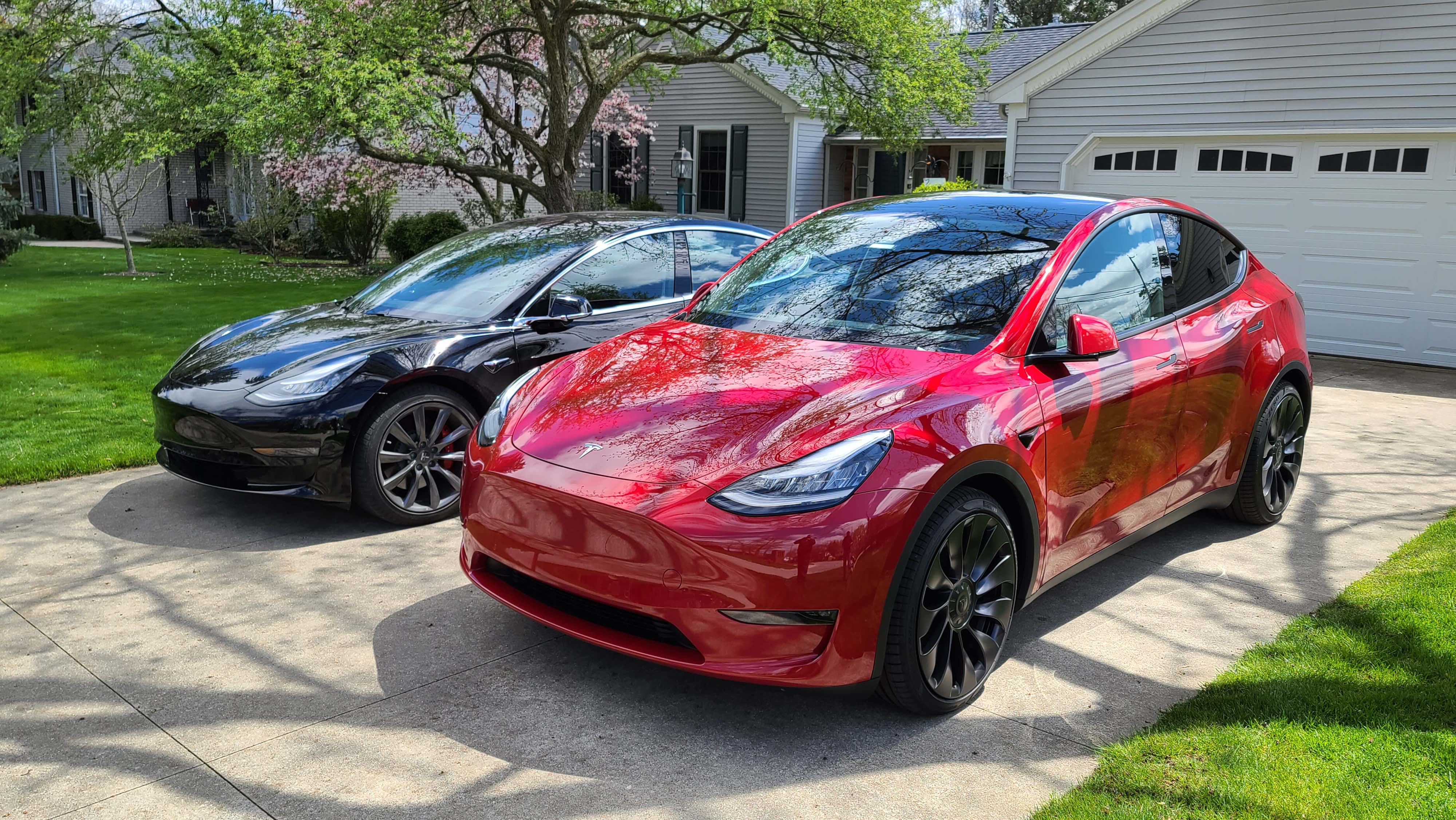 The Tesla Model Y (right) is taller and wider than it Model 3 sedan sibling.