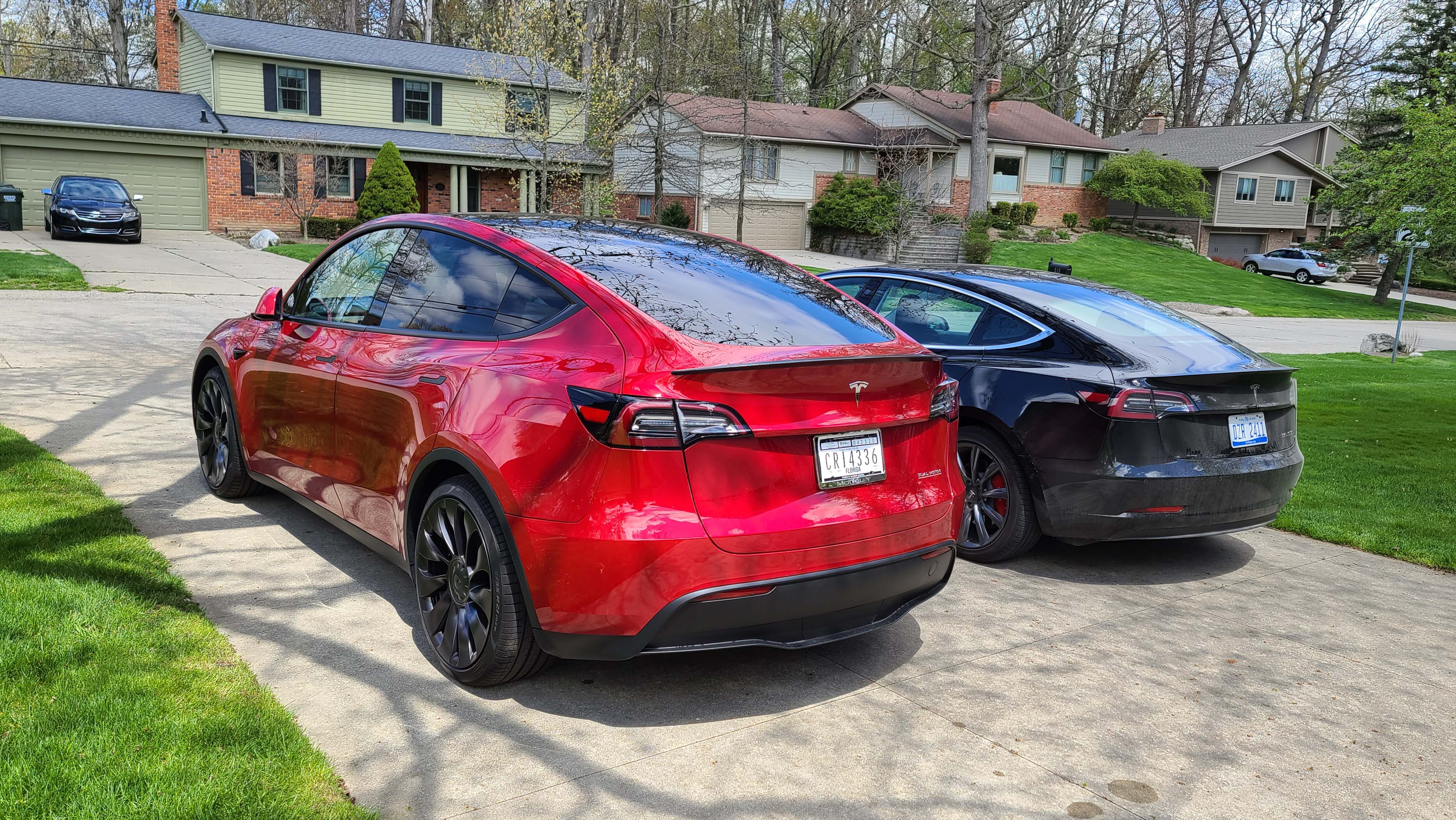 The Tesla Model Y (left) has similar ground clearance to the Model 3 sedan but has a taller SUV seating position and roofline for more interior room.