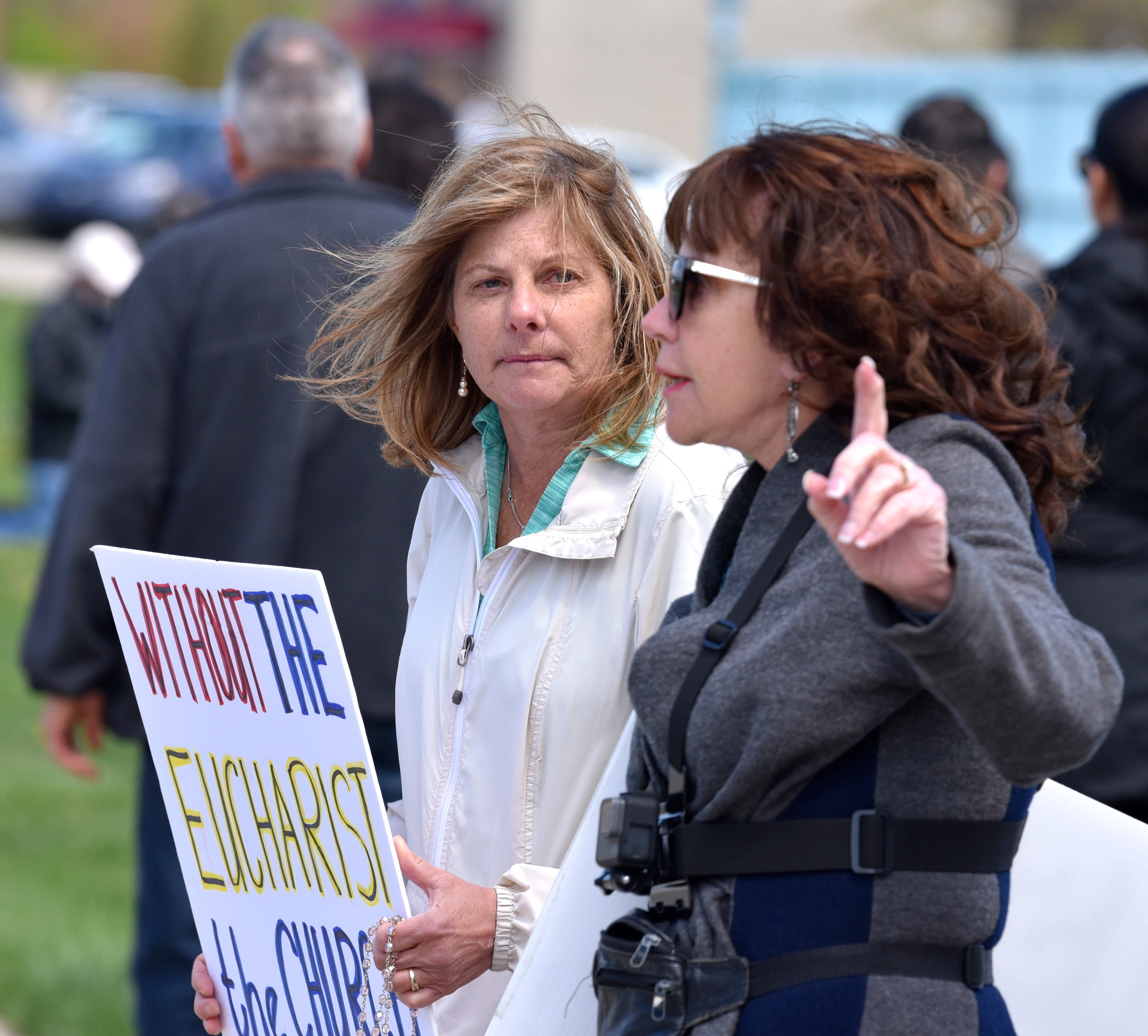 Co-organizers Patricia Stephanoff, left, and Lynn Mills, both of Livonia, talk during the action.