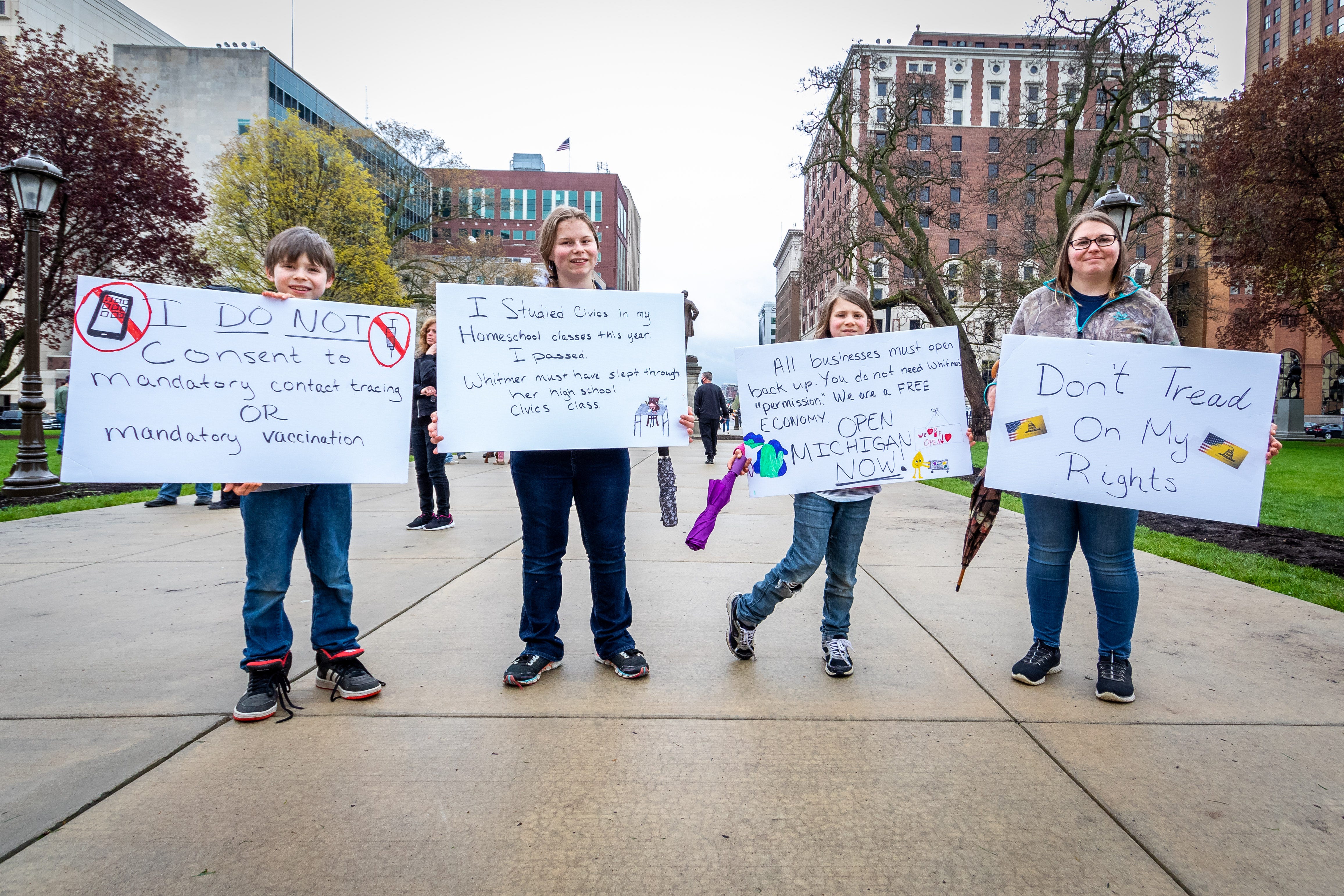 The Dickens family from left to right;  Ethan, 11, Alexis, 15,
Charlotte, 9, and their mother Melissa from Hillsdale County joined the protest.