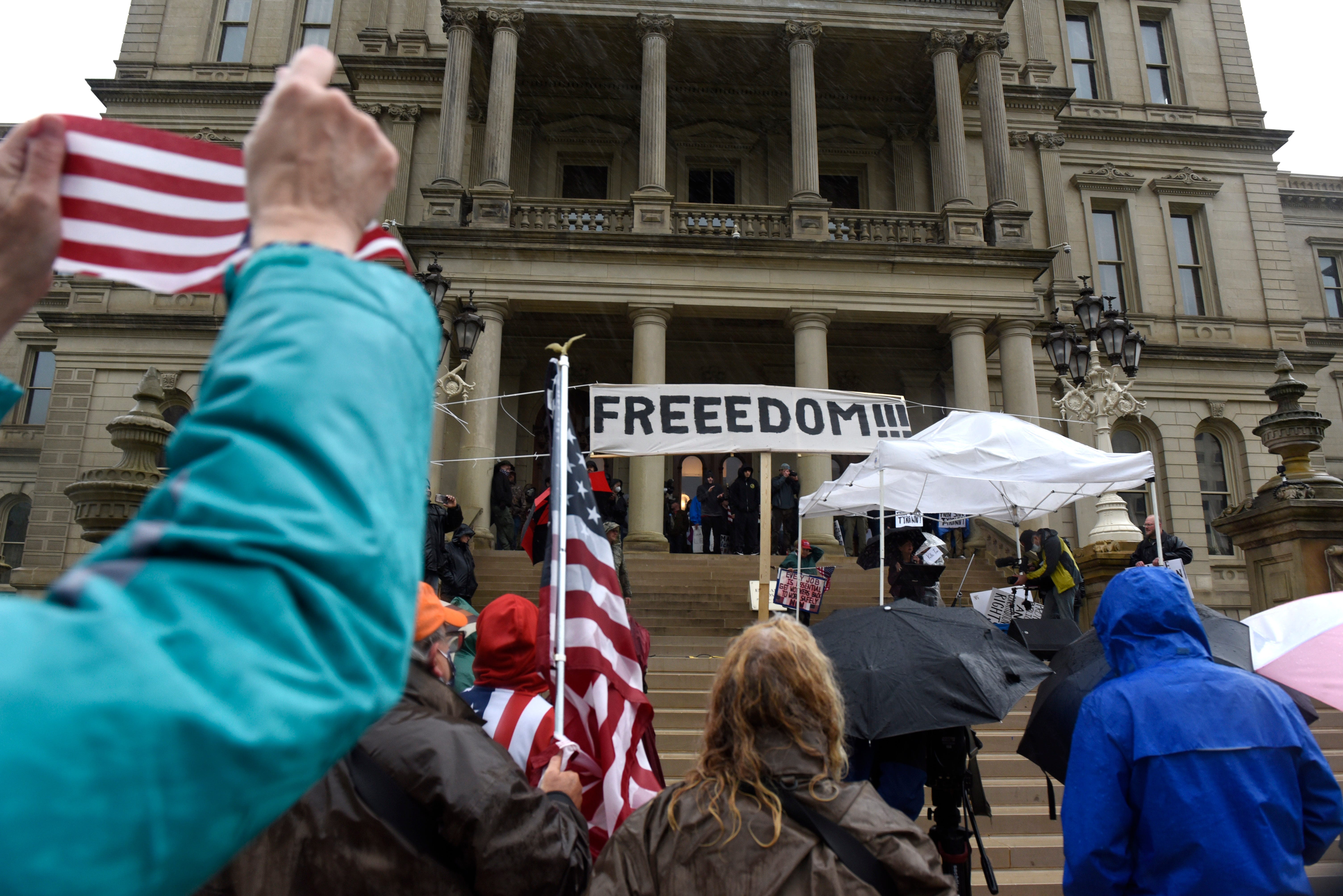 Protesters listen to speakers during a protest at the state Capitol.