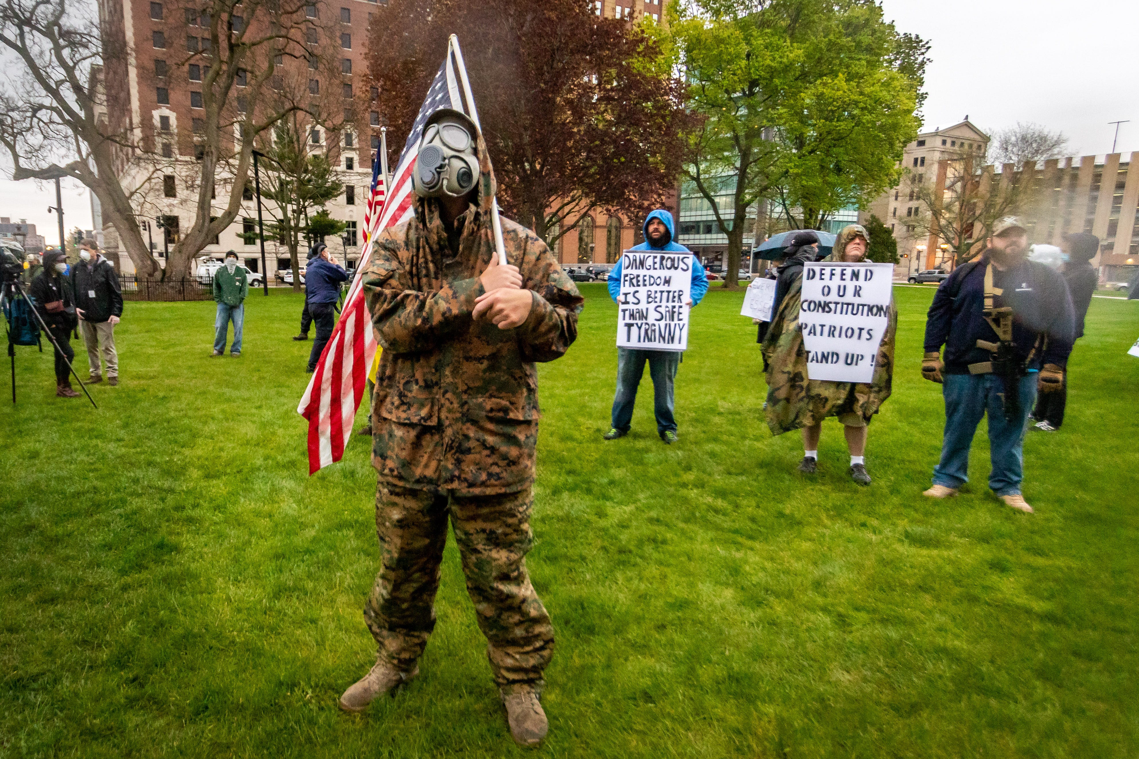 Joel Gardner from Lansing wears a gas mask at the protest.
