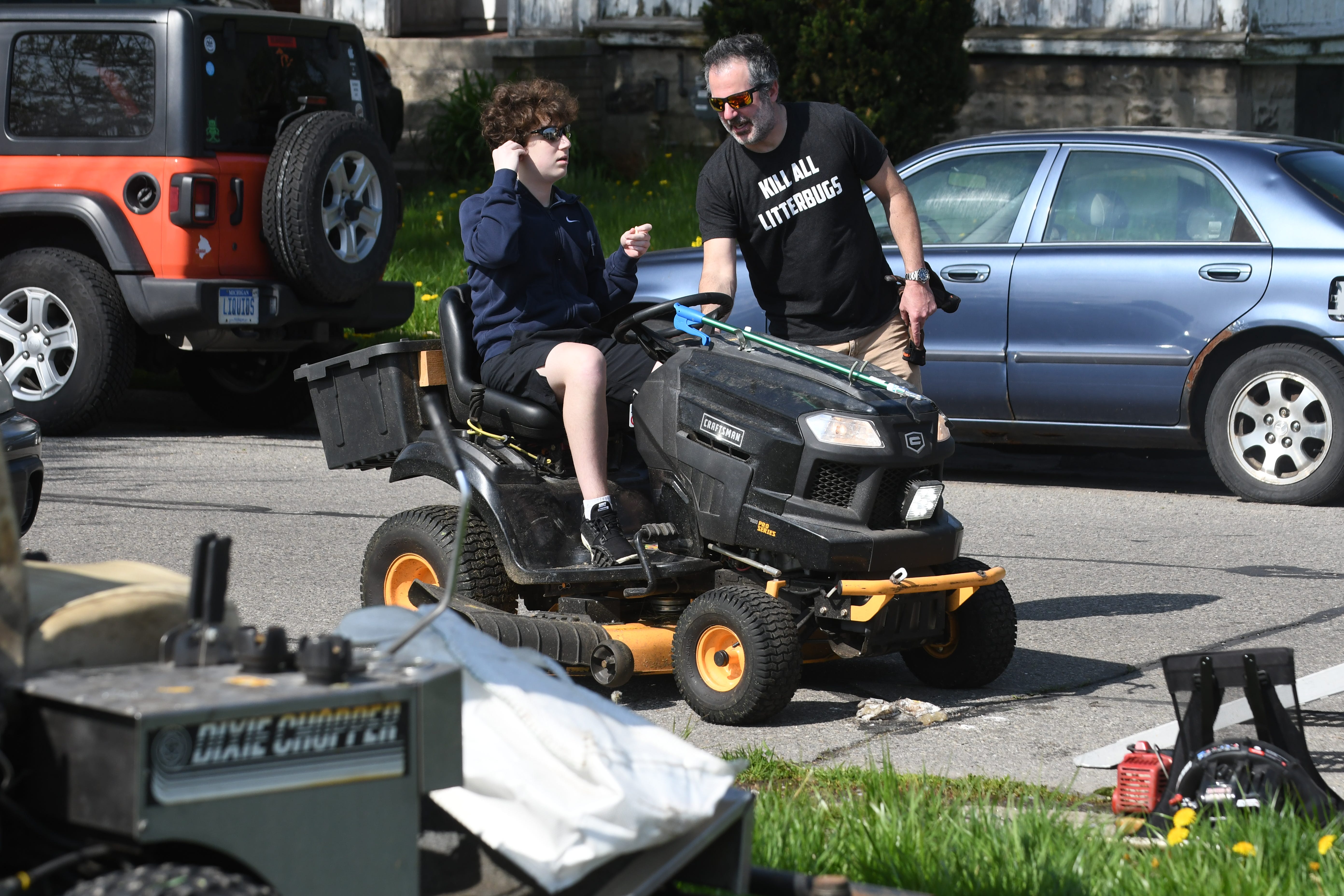 Tom Nardone, founder, Detroit Mower Gang, instructs his son Michael, left, on the cutting path at Hammerberg Playfield for the 2020 Motown Mowdown