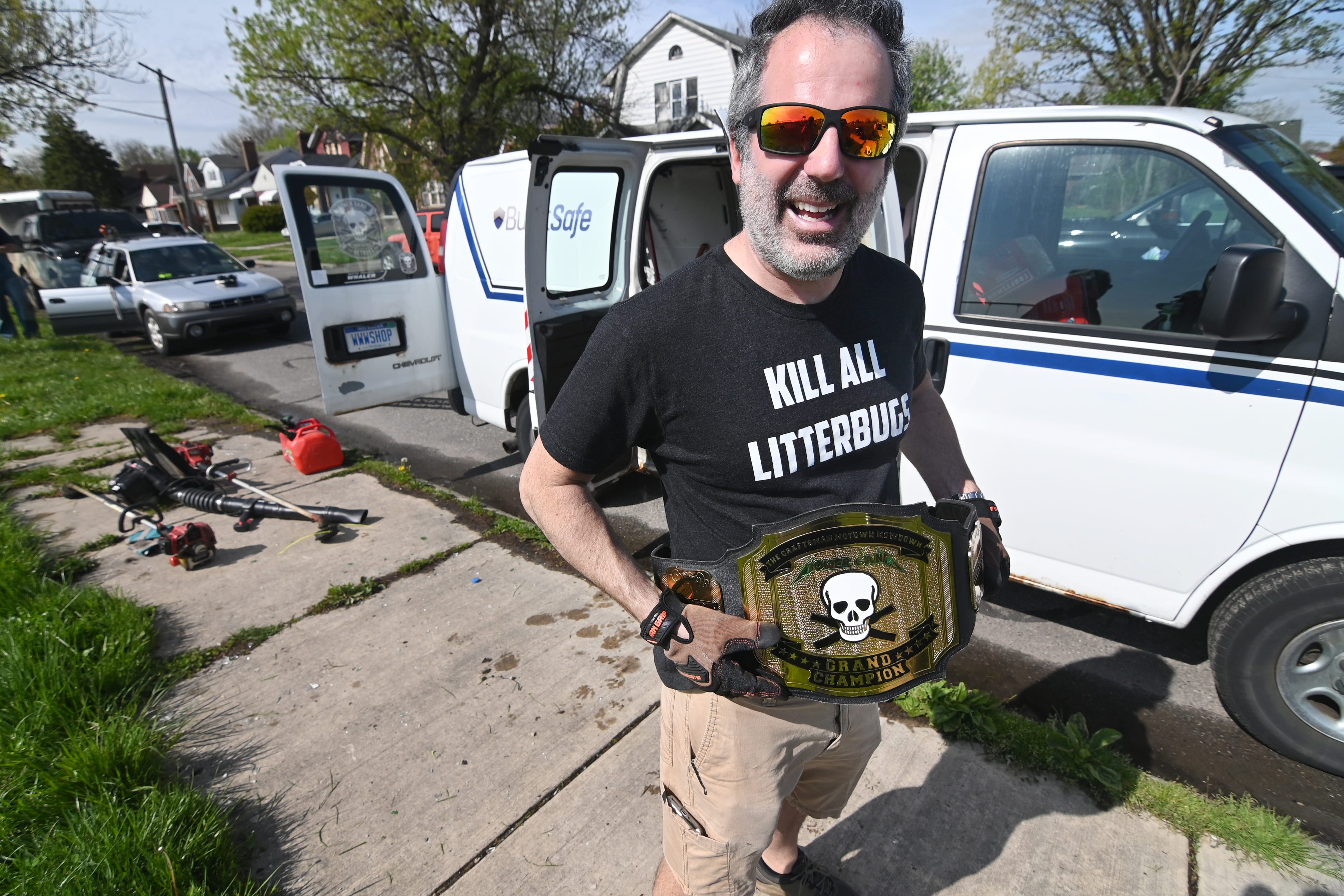 Tom Nardone, founder, Detroit Mower Gang, shows off the championship belt given to the member who mows the most grass in their 12- hour mowing marathon called the 2020 Motown Mowdown.